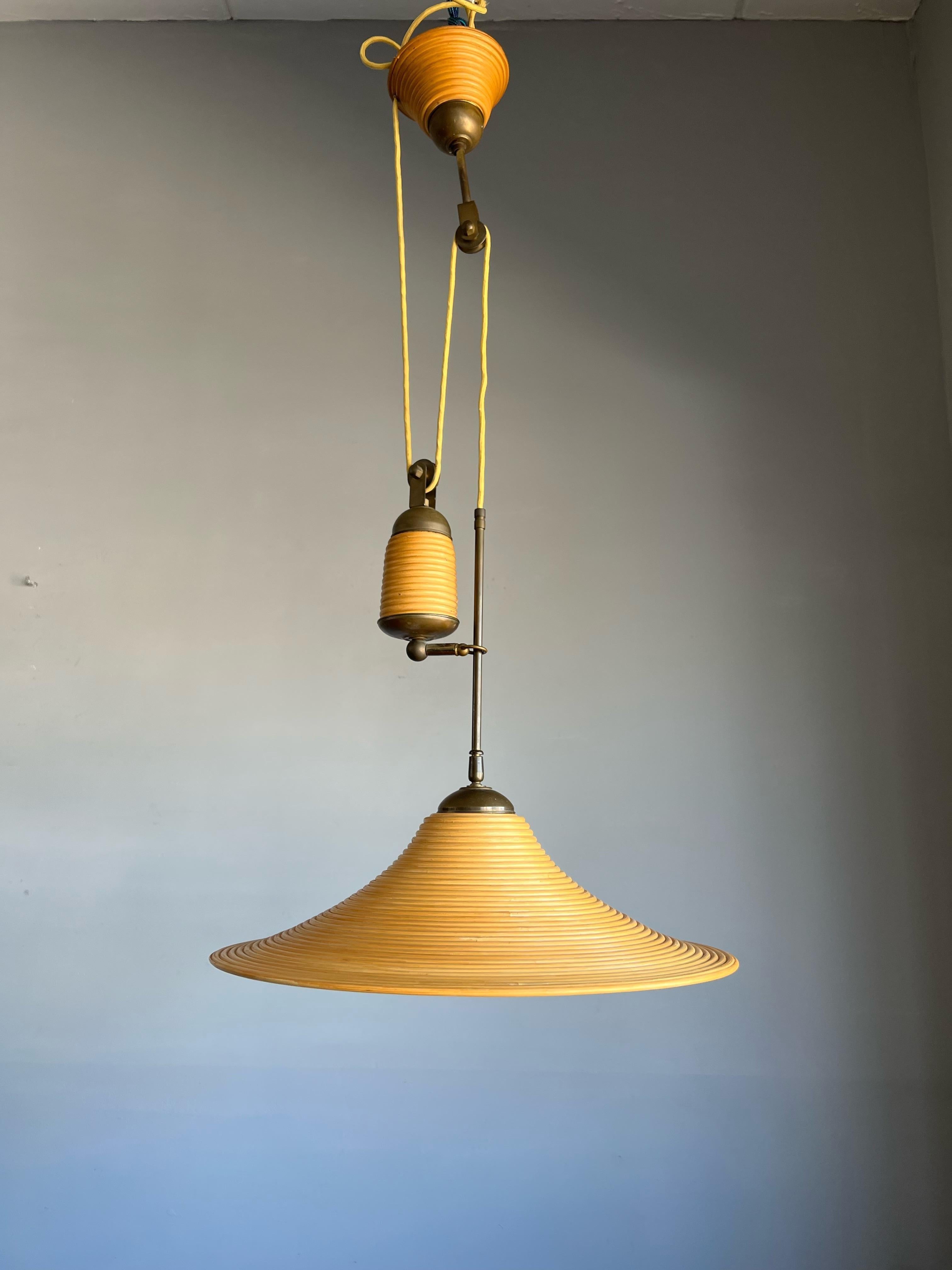 Stylish midcentury made and height adjustable light fixture.

This rare 1970s light fixture is ideal for bringing good style and the perfect kind of light to your midcentury kitchen, hallway, living room, landing etc. This pendant comes with a