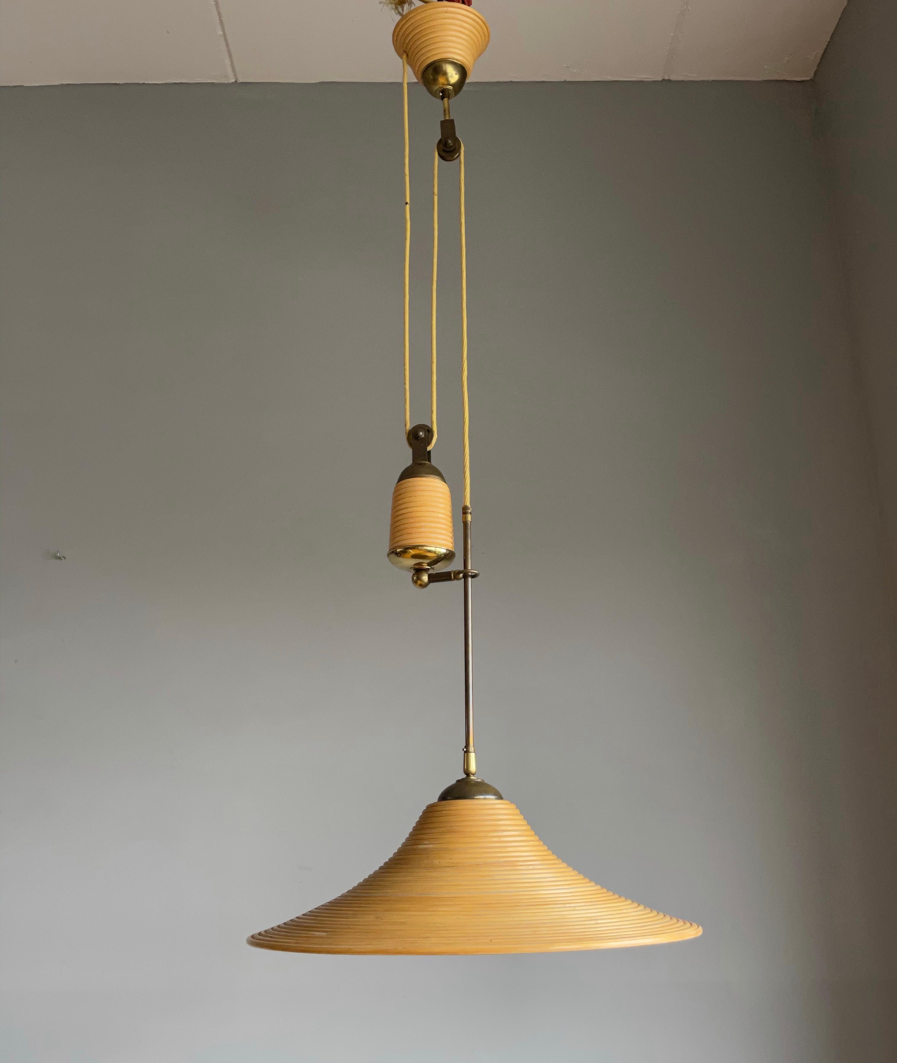 Stylish midcentury made and height adjustable light fixture.

This rare 1970s light fixture is ideal for bringing good style and the perfect kind of light to your midcentury kitchen, hallway, living room, landing etc. This pendant comes with a