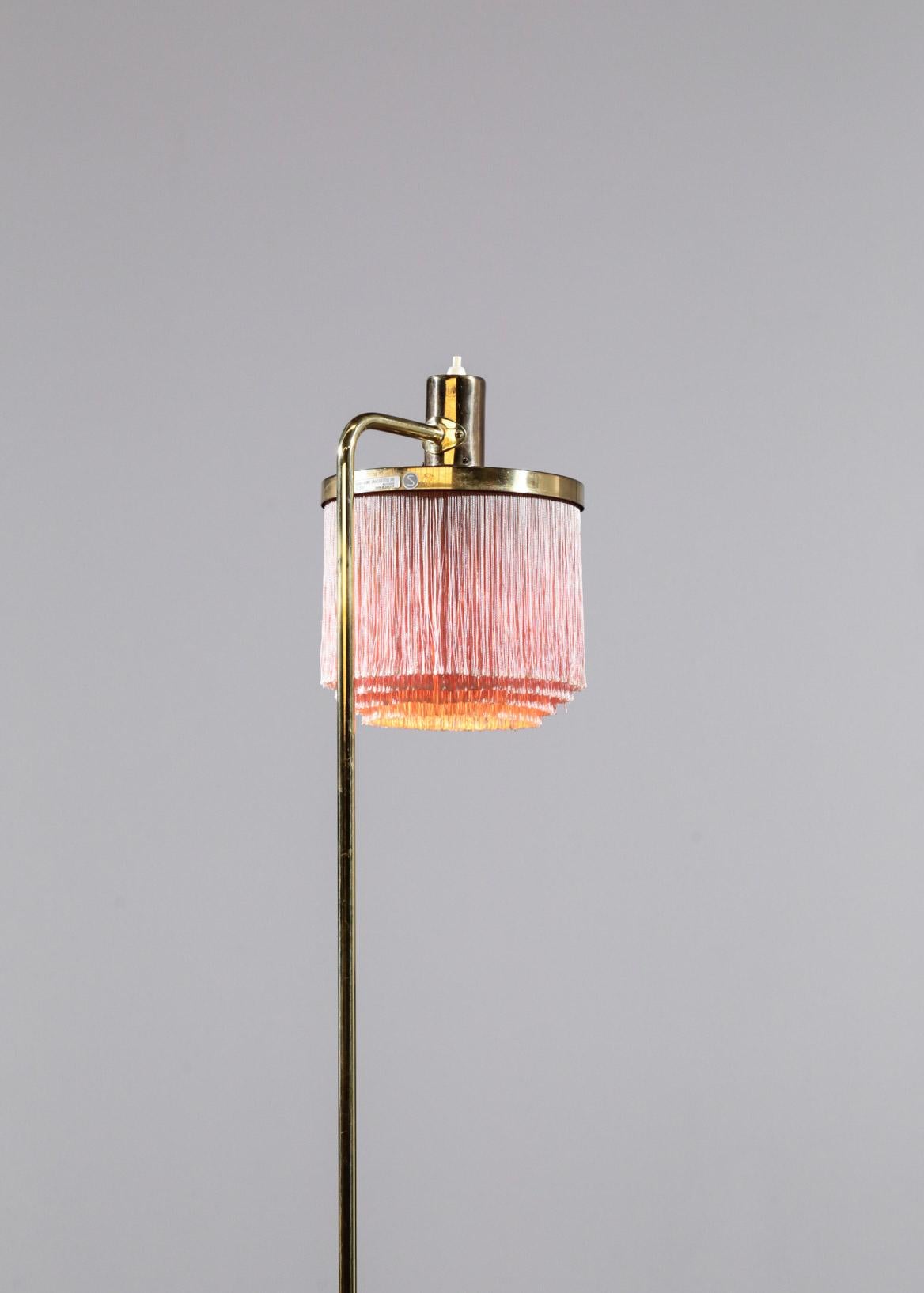 Rare floor lamp from Hans Agne Jakobsson, model G109 with rose fringe and brass.