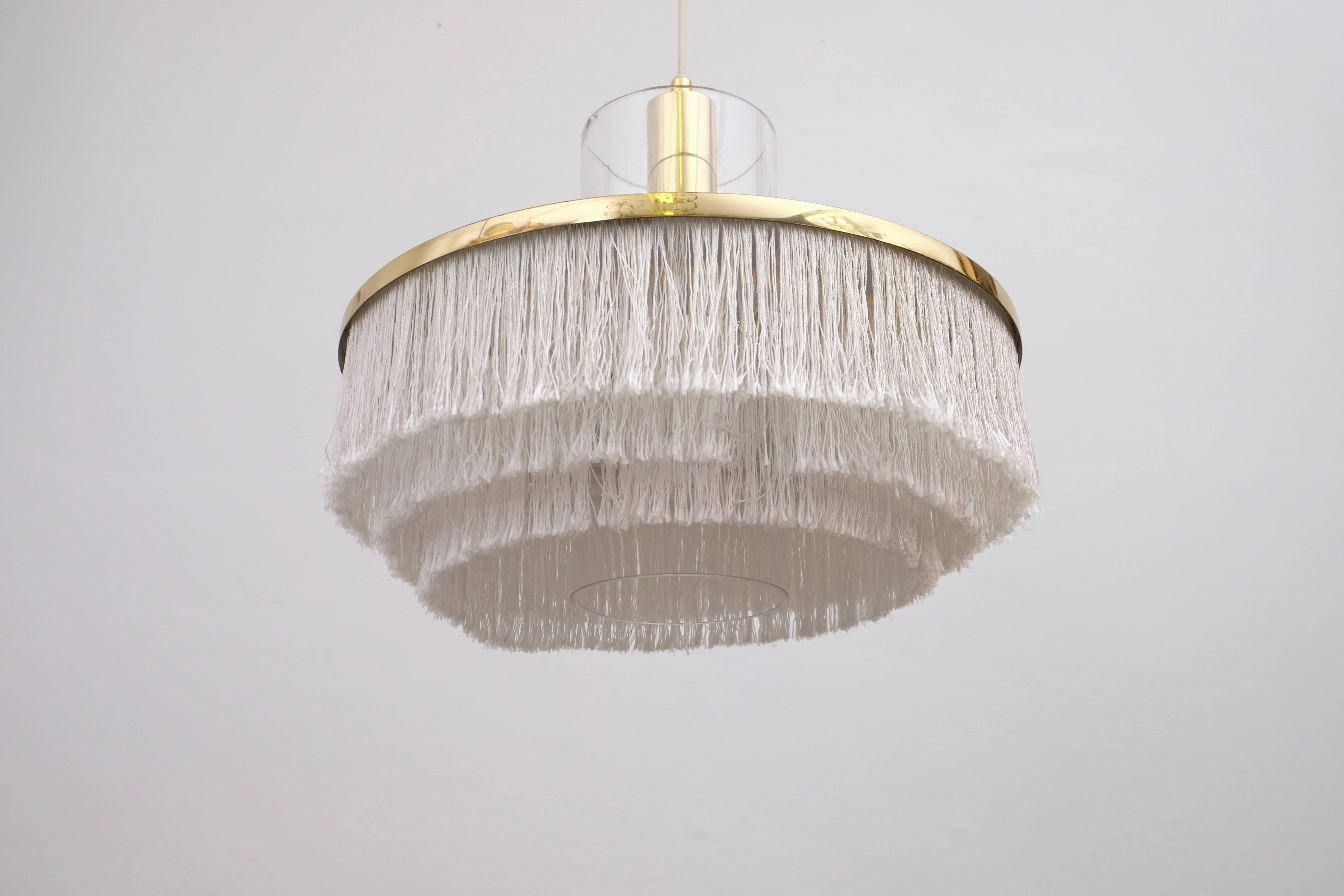 Hans-Agne Jakobsson, pendentif cylindrique à franges blanches et verre, années 1960.
Produit en Suède par Hans-Agne Jakobsson AB à Markaryd, dans les années 1960.
   
   