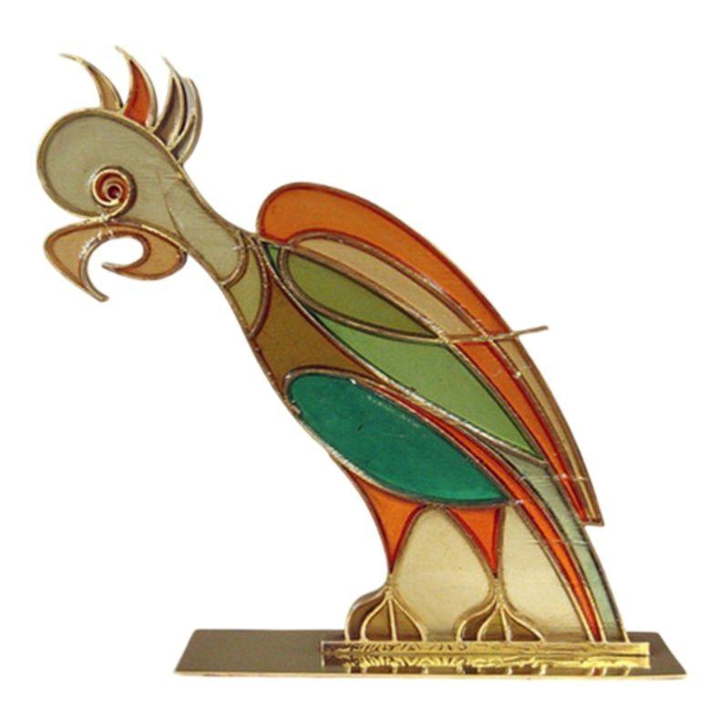 This rare set of 1920s Austrian celluloid rooster and parrot figures by Hans Hagenauer (1896-1975) feature soft, pleasing colors which contrast nicely with their brass frames and mounts. These designs were a limited edition, stamped beneath, 