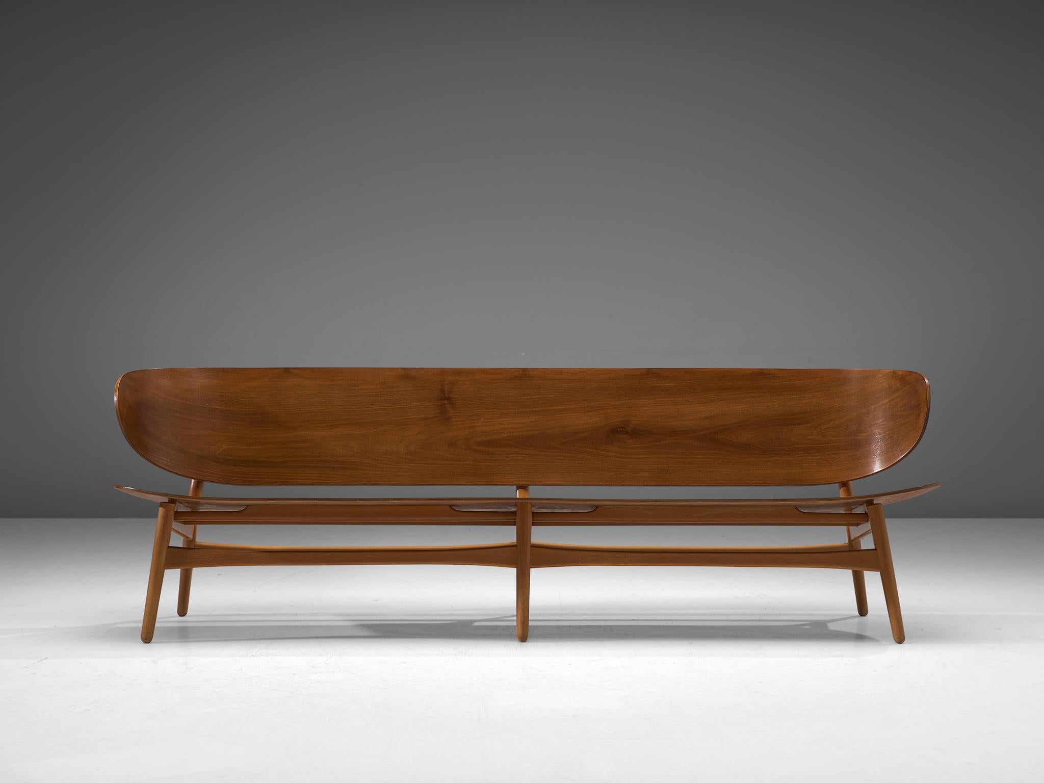 Hans J. Wegner for Fritz Hansen, FH 1935/4 bench, walnut and beech, Denmark, design 1948, manufactured circa 1950

This rare and largest version ever made of the FH 1935 bench with sofa appeal by Hans J. Wegner. This piece is one of the results of