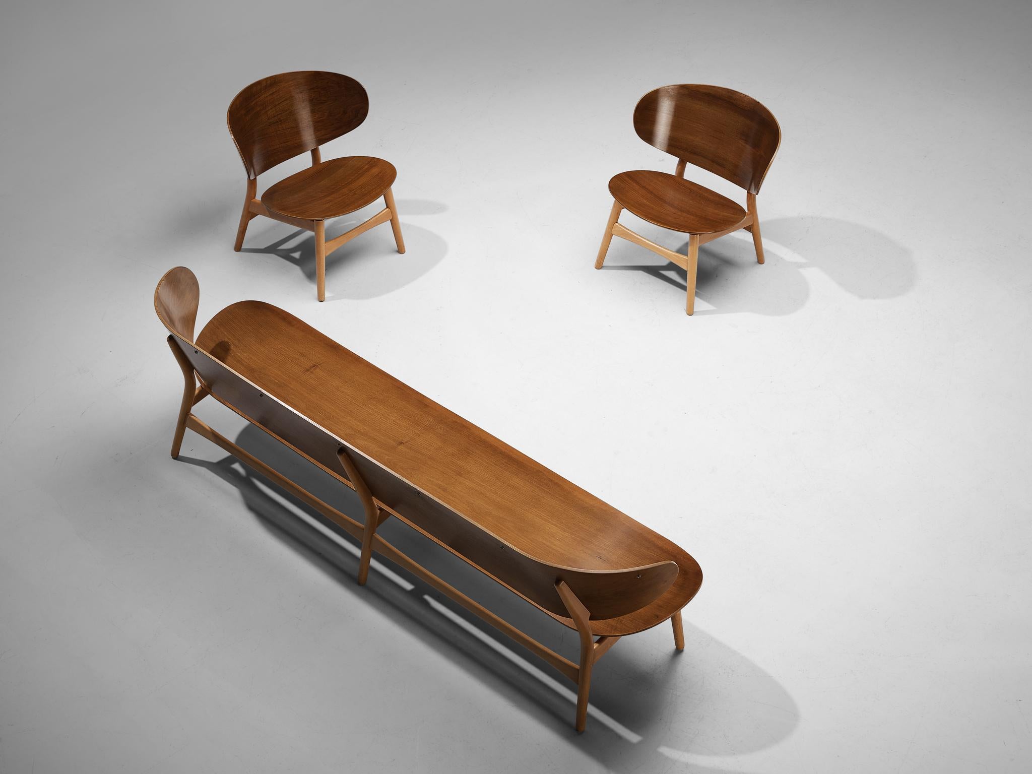 Hans J. Wegner for Fritz Hansen, sofa bench model 'FH 1935/4' and pair of lounge chairs model 'FH 1936', walnut and beech, Denmark, design 1948, manufactured, circa 1950.

This living room set consists of two 'FH 1936' lounge chairs and a 'FH
