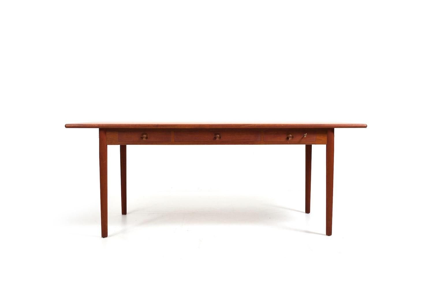 Rarely offered  Hans J. Wegner desk in sold teak. Model PP-312. This is probably an earlier version of the current PP-312. Like its predecessor, the PP-305, this model still has three drawers in the front.
