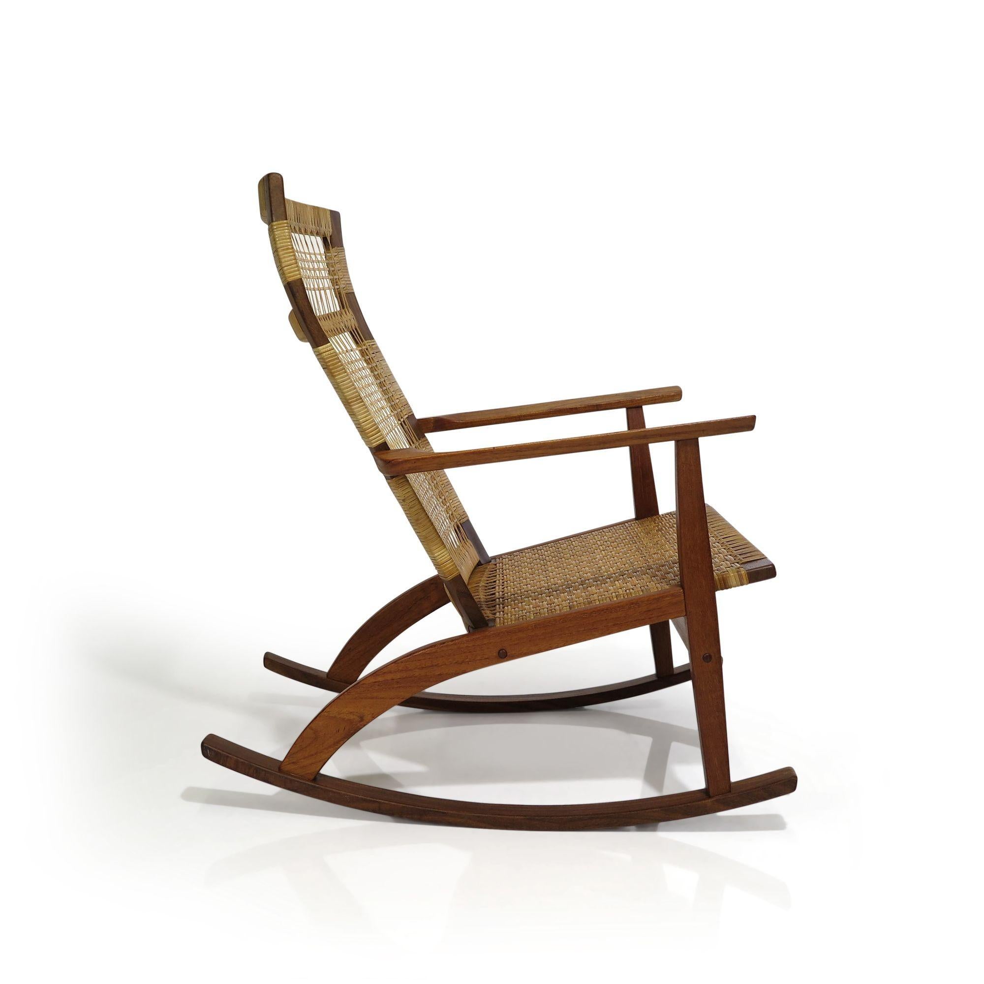 Danish Teak rocking chair designed by Hans Olsen for Juul Kristensen, 1955, Denmark. The chair is crafted of solid teak with woven cane seat and back. The chair has been lightly cleaned and oiled.
Measurements
W 25.25'' x D 32.25'' x H 34.75''