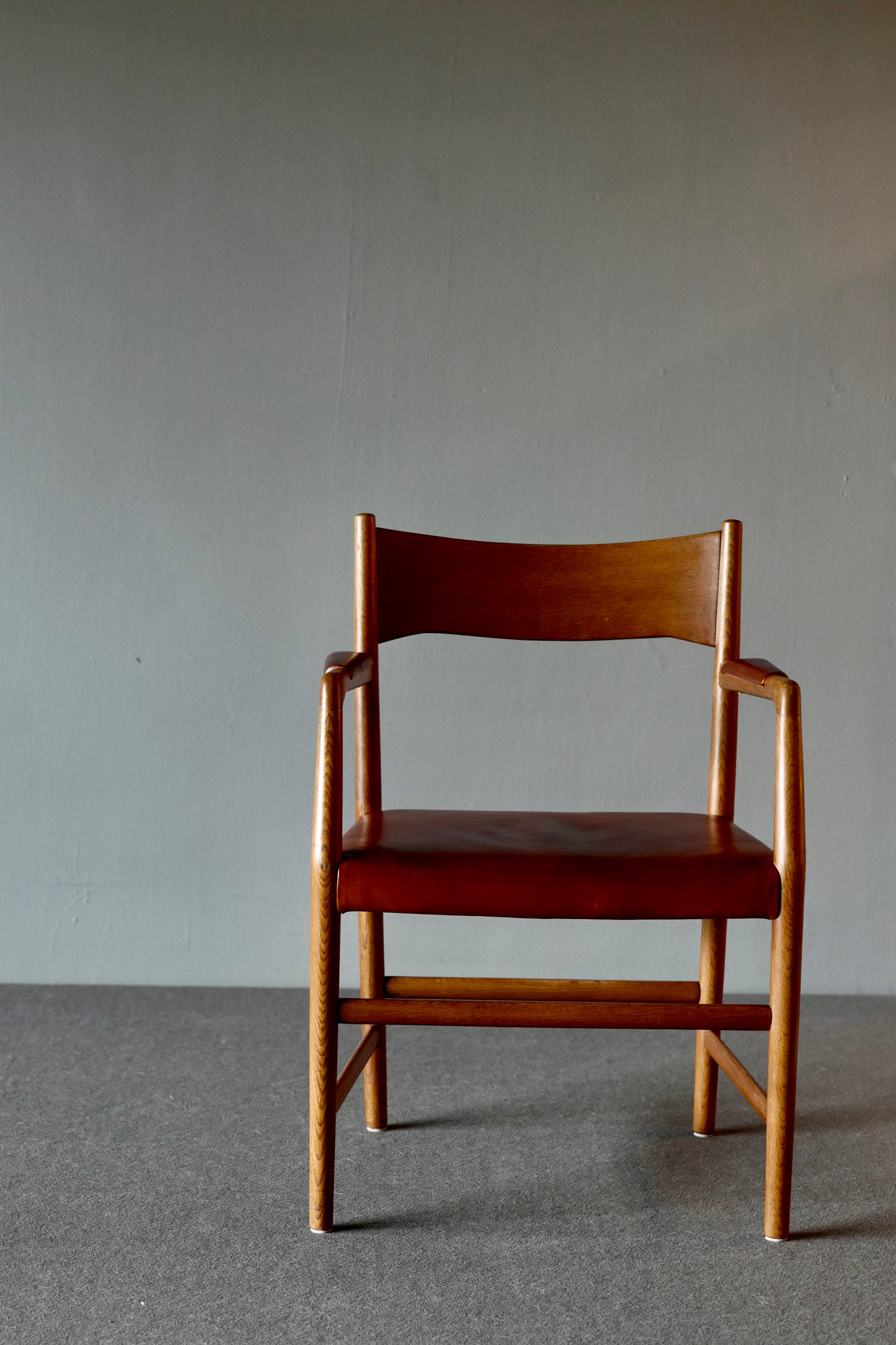 Armchairs, called the “Town Hall’ chairs by Hans Wegner for Plan Møbler. They have a solid oak frame and are upholstered with well patinated cognac colored leather, circa 1940s

These chairs were part of the furniture for the Aarhus City Hall