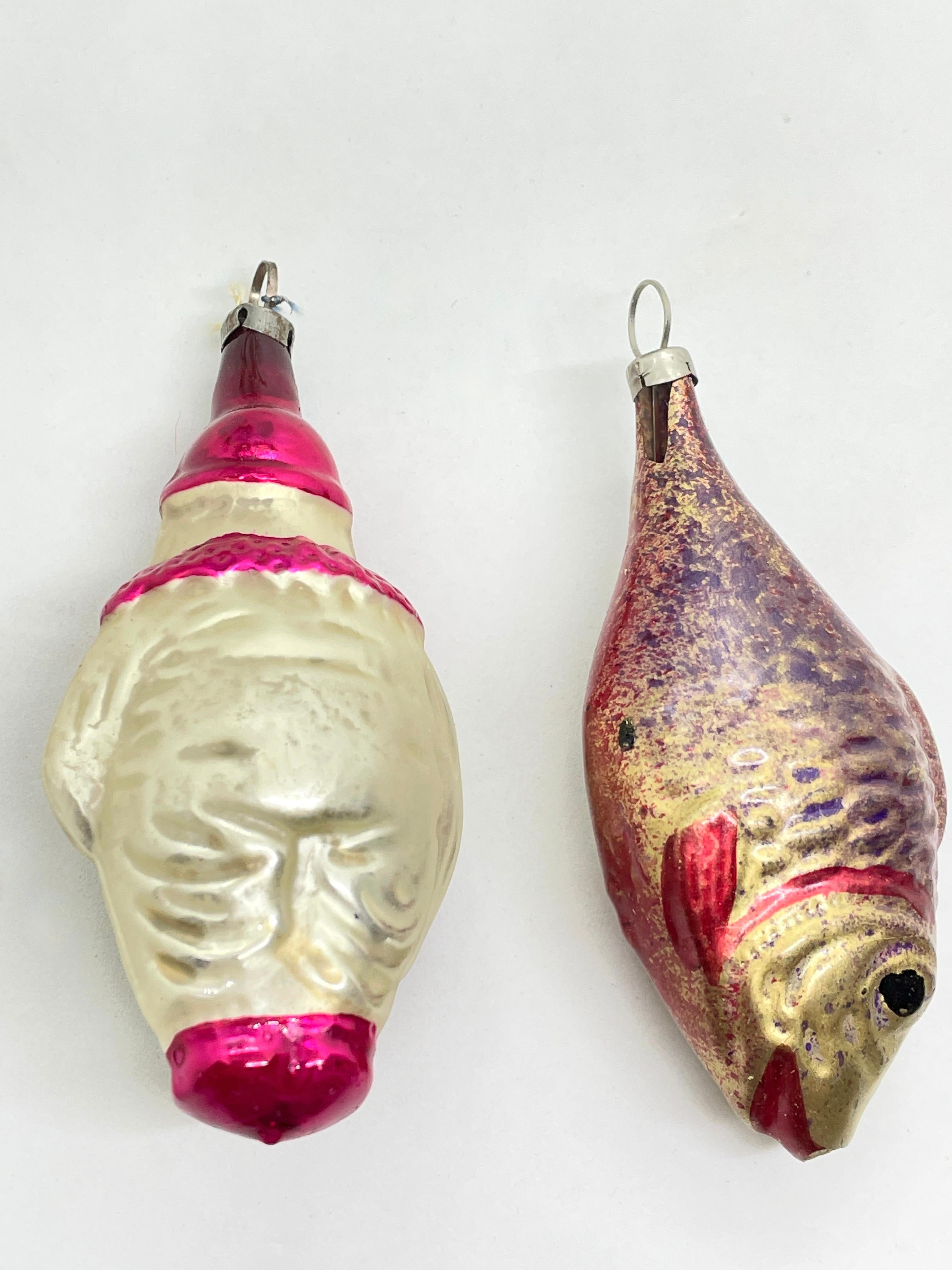 A rare Christmas ornament set of two. Each is made from thin mouth blown glass, this would be a great antique addition for your Christmas or feather tree. Fish is approx. 3 1/4