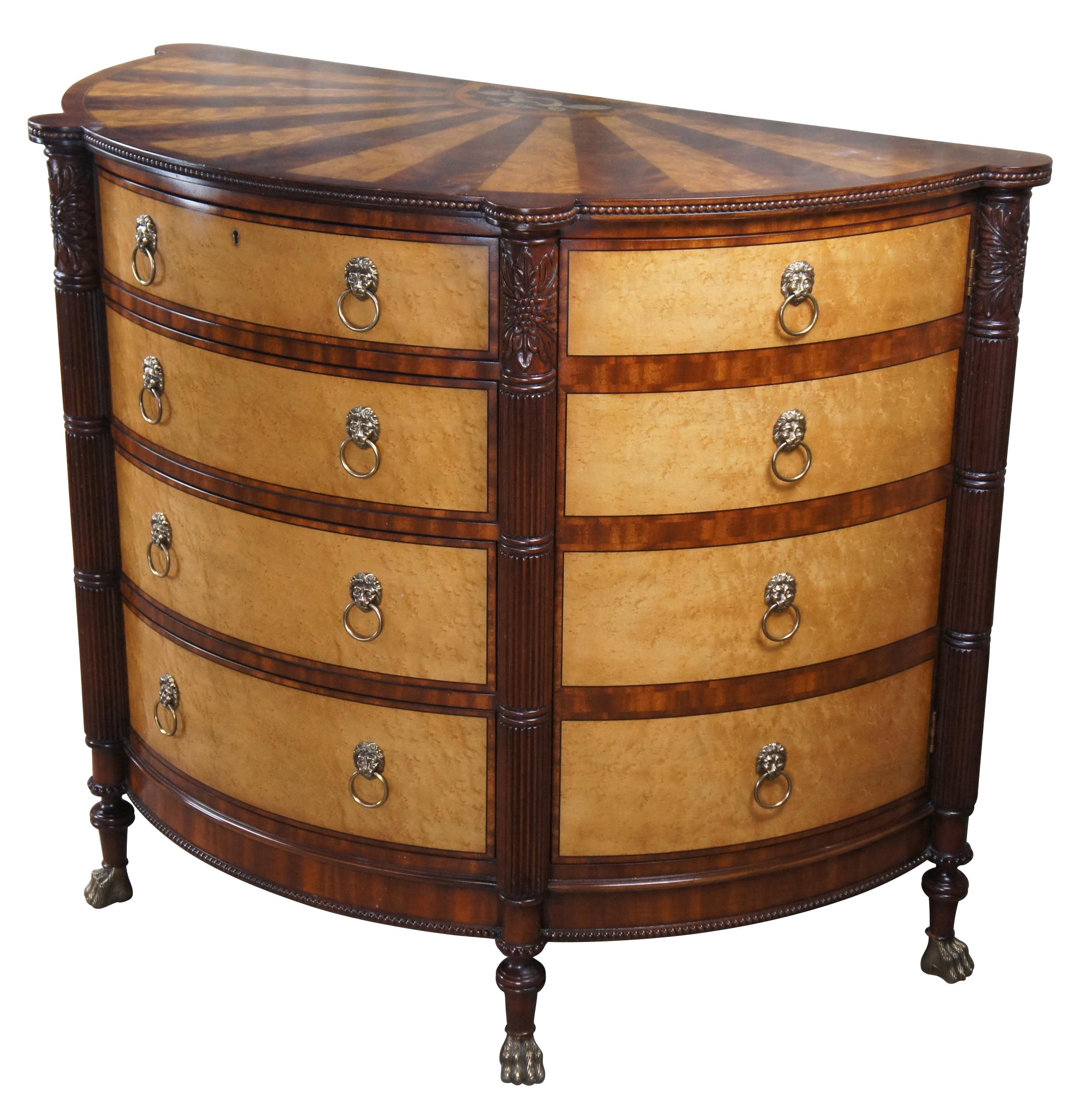 A rare and impressive commode by Harold Ionson. Made of birdseye maple, satinwood and Honduras mahogany, featuring a half round / bow front with four drawers, two side cabinets, brass paw / claw feet and superb sunburst / starburst top with nautical