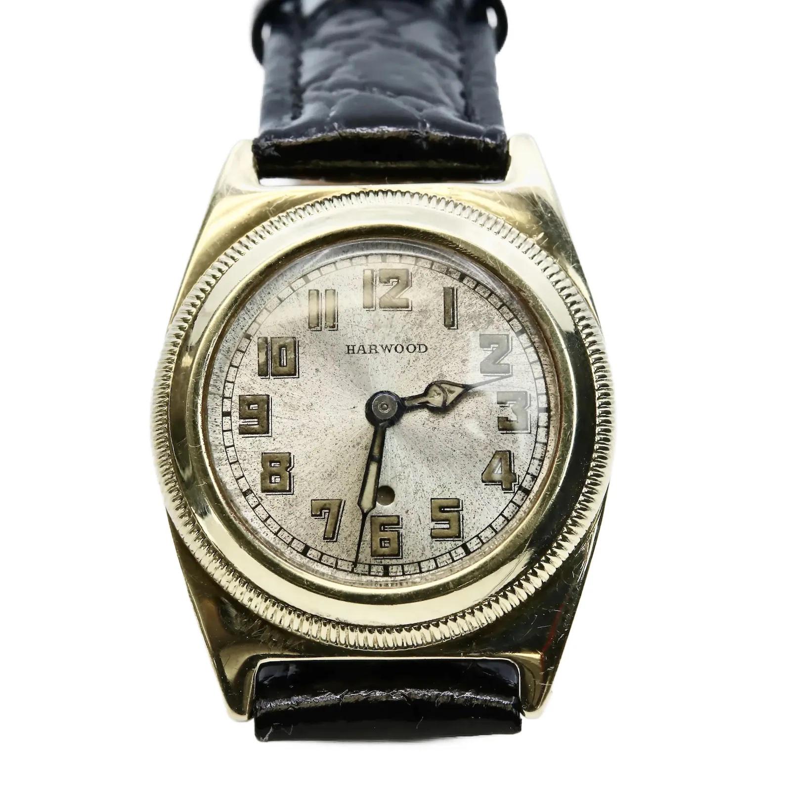 A rare early example of a John Harwood wrist watch circa the early 1920's. Found in a very rare solid 14 karat gold case, this watch is a fantastic example of the first automatic wrist watch ever produced. This watch features a silver dial in