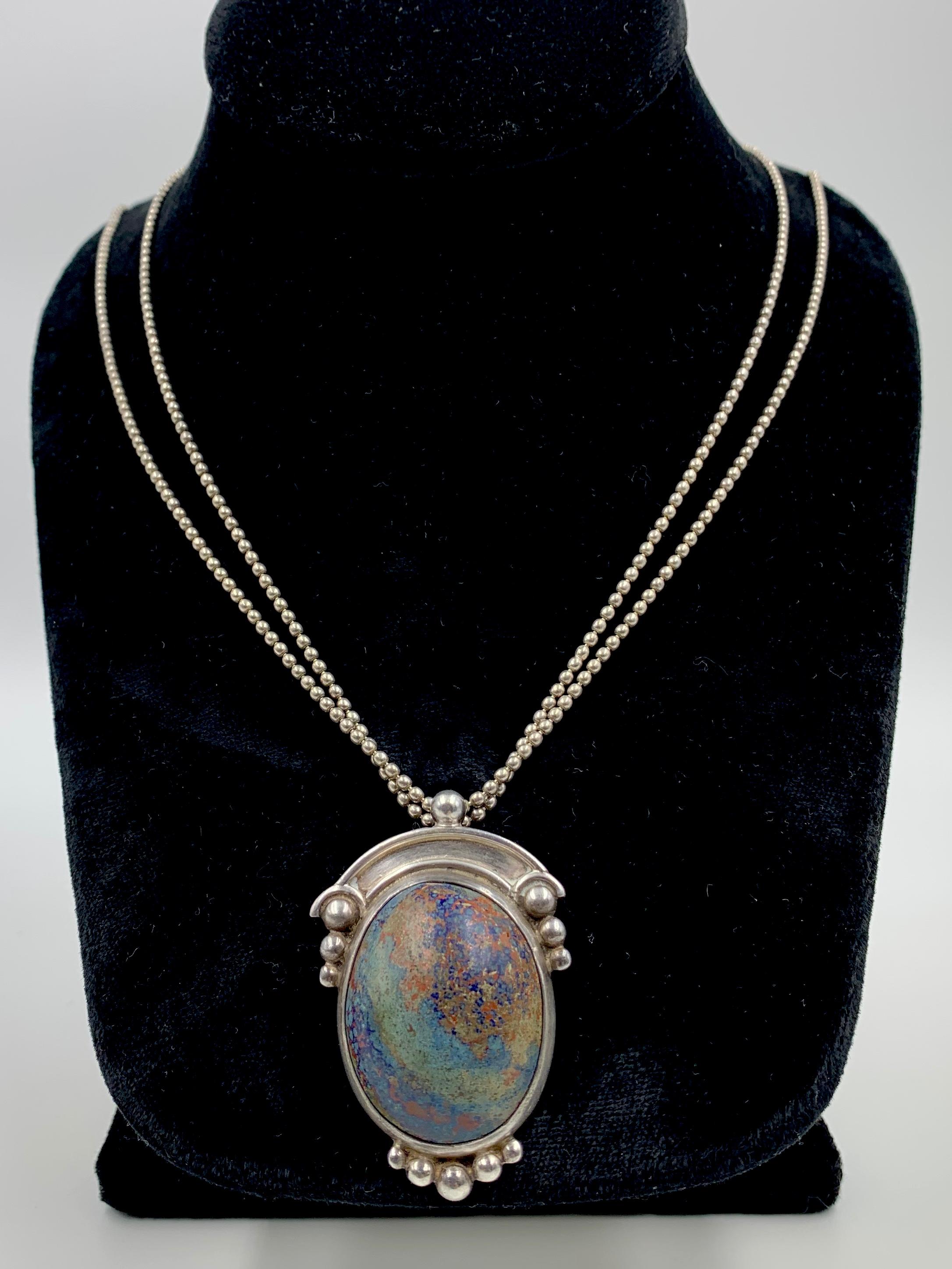 This beautiful rare necklace features a most spectacular crysocolla cabochon stone measuring 31mm by 25mm with superb inclusions forming an image one might see looking at the earth's surface from space. The stone's name is derived from the Greek
