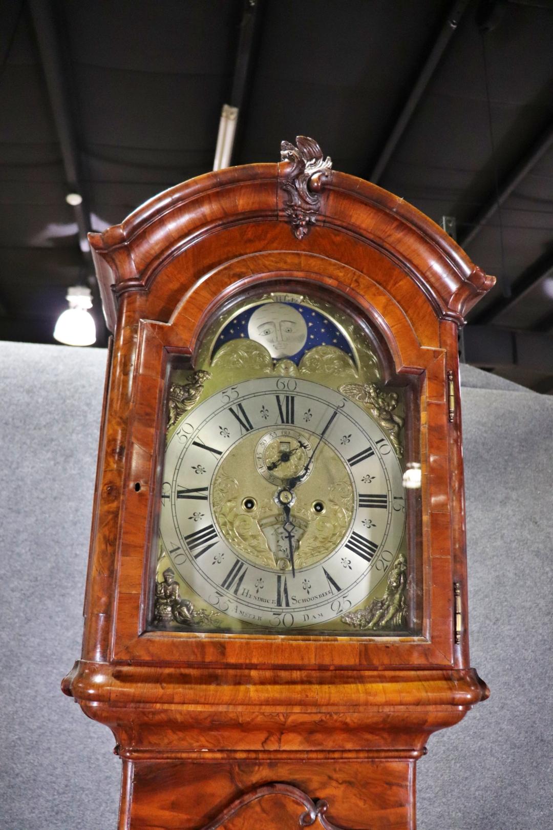 Signed Hendrick Schoonbeek, Amsterdam

The arched hood with molded cornice above a shaped long door inlaid with checkerboard parquetry, the similarly inlaid shaped plinth raised on bracket feet, the dial with aperture for age and aspect of the moon