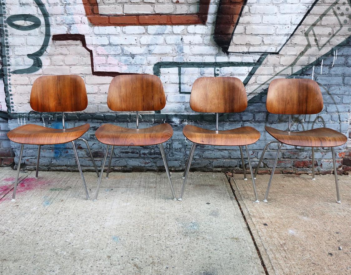 Rare matching set of 4 Herman Miller Eames DCM dining chairs in rosewood. All signed Herman Miller. Beautiful color and grain texture. From an original set purchased together. All chairs in good condition with age appropriate wear. No chipped
