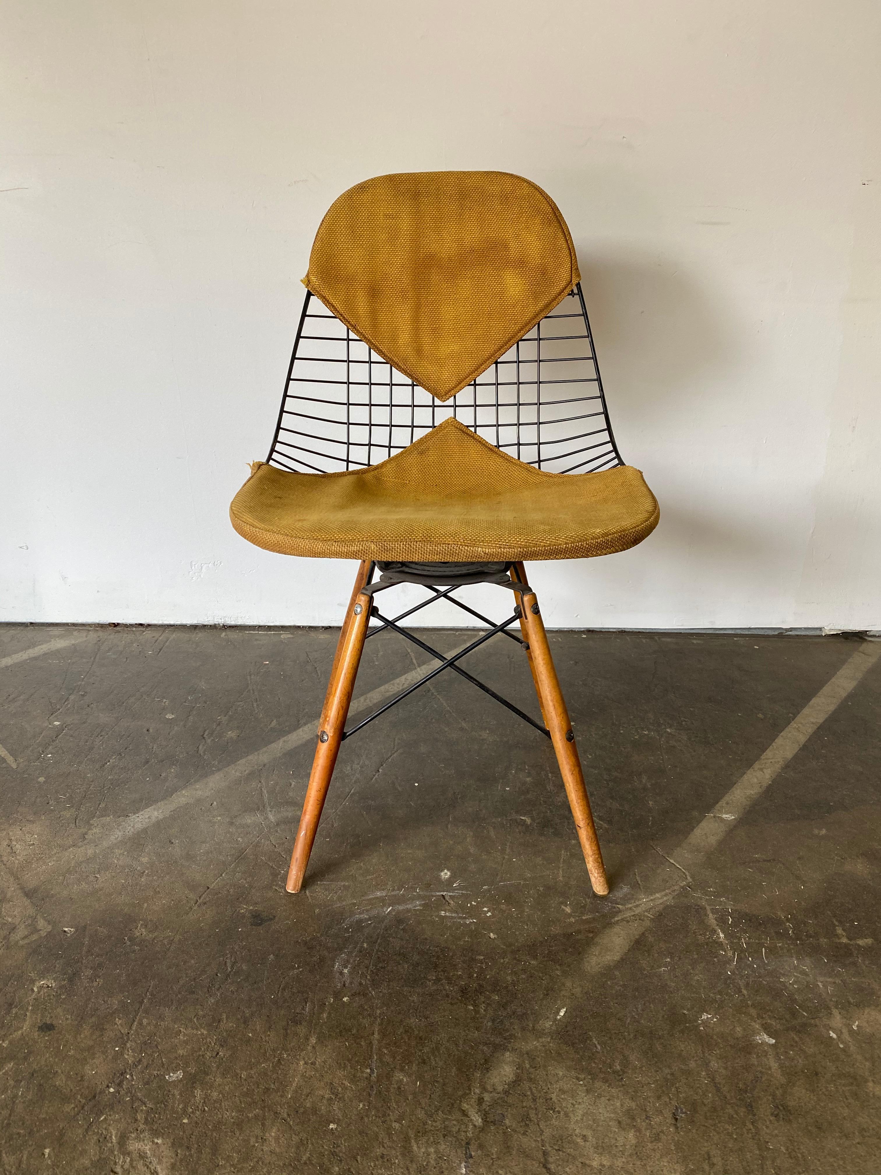 This is not one you see every day. Pleased to offer a rare Herman Miller Eames wire chair with Alexander Girard upholstery pads and swivel base. Original wooden dowels intact. Signed and guaranteed authentic. This chair dates to the very beginning