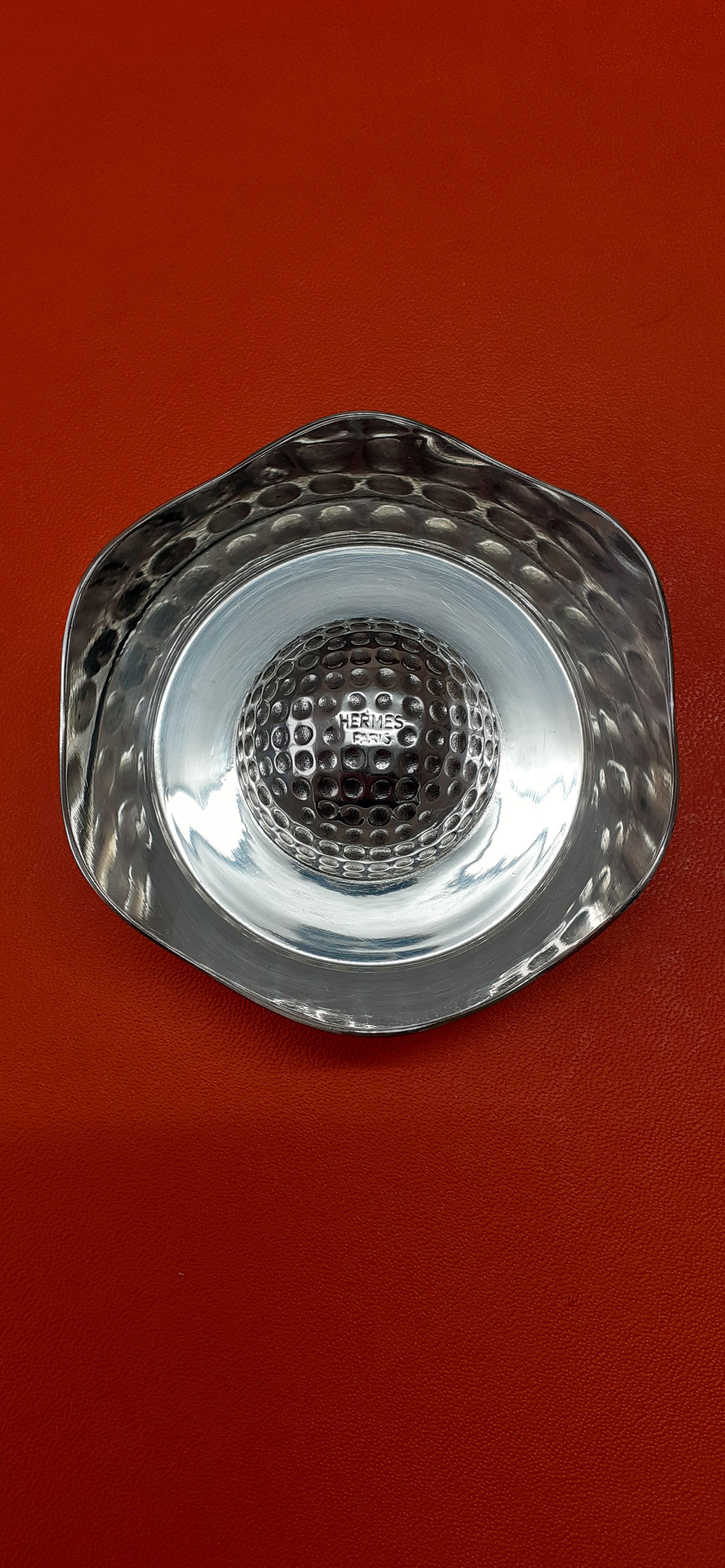 Exceptional Authentic Hermès Change Tray

Pattern: Golf

Made in France by Ravinet d'Enfert for Hermès

Vintage item

Made of silver-tone metal (non precious)


