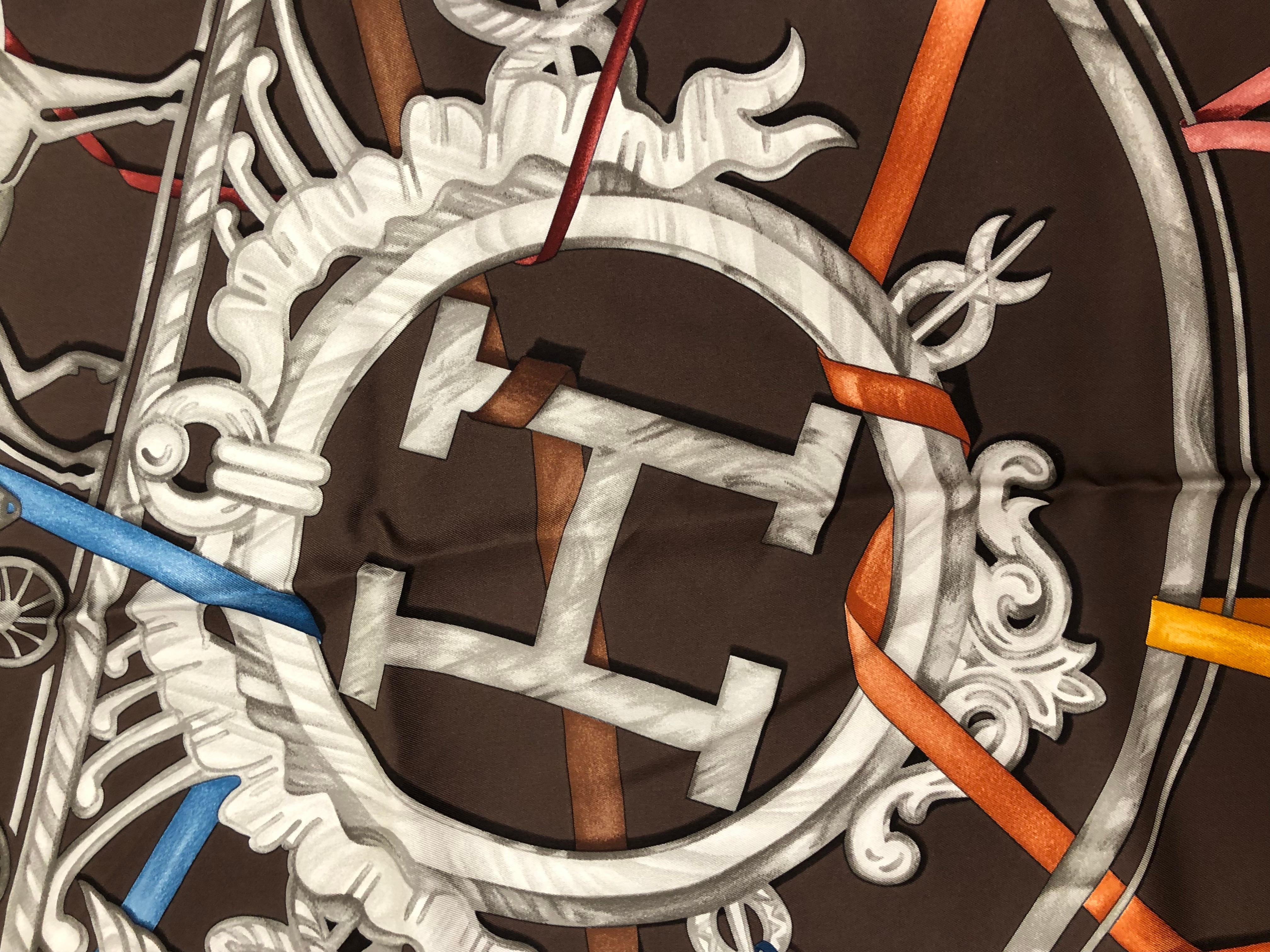 This  is a 2008 Hermes silk scarf designed by Leigh Cooke which pays homage to the Hermes logo. It has one small stain which I have not tried to clean (picture attached), but otherwise is in great condition. 
