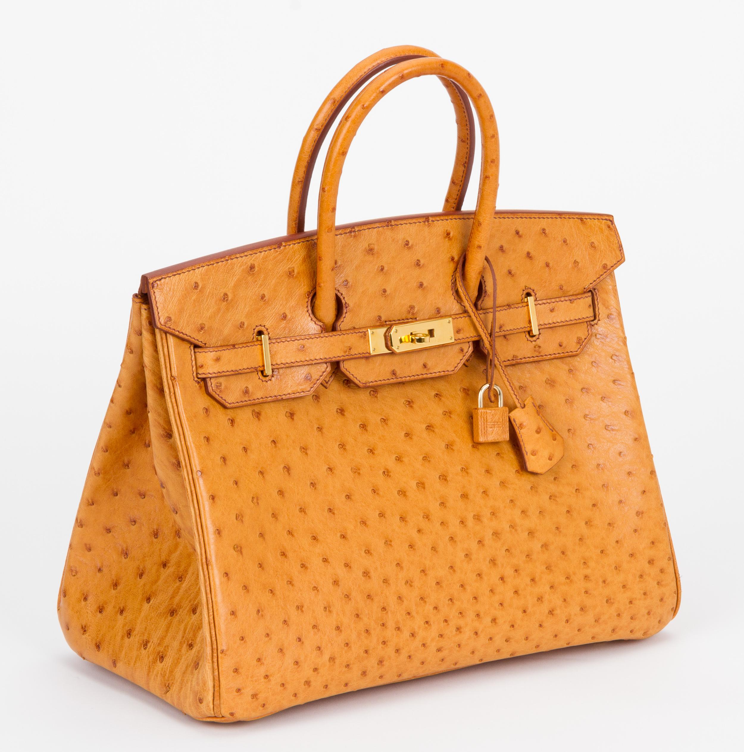 Hermes rare and mint birkin 35 cm in sable ostrich leather with gold tone hardware. Date stamp D for 2000. Comes with clochette, tirette, two locks, keys, dust cover and original box. Box is slightly damaged.
