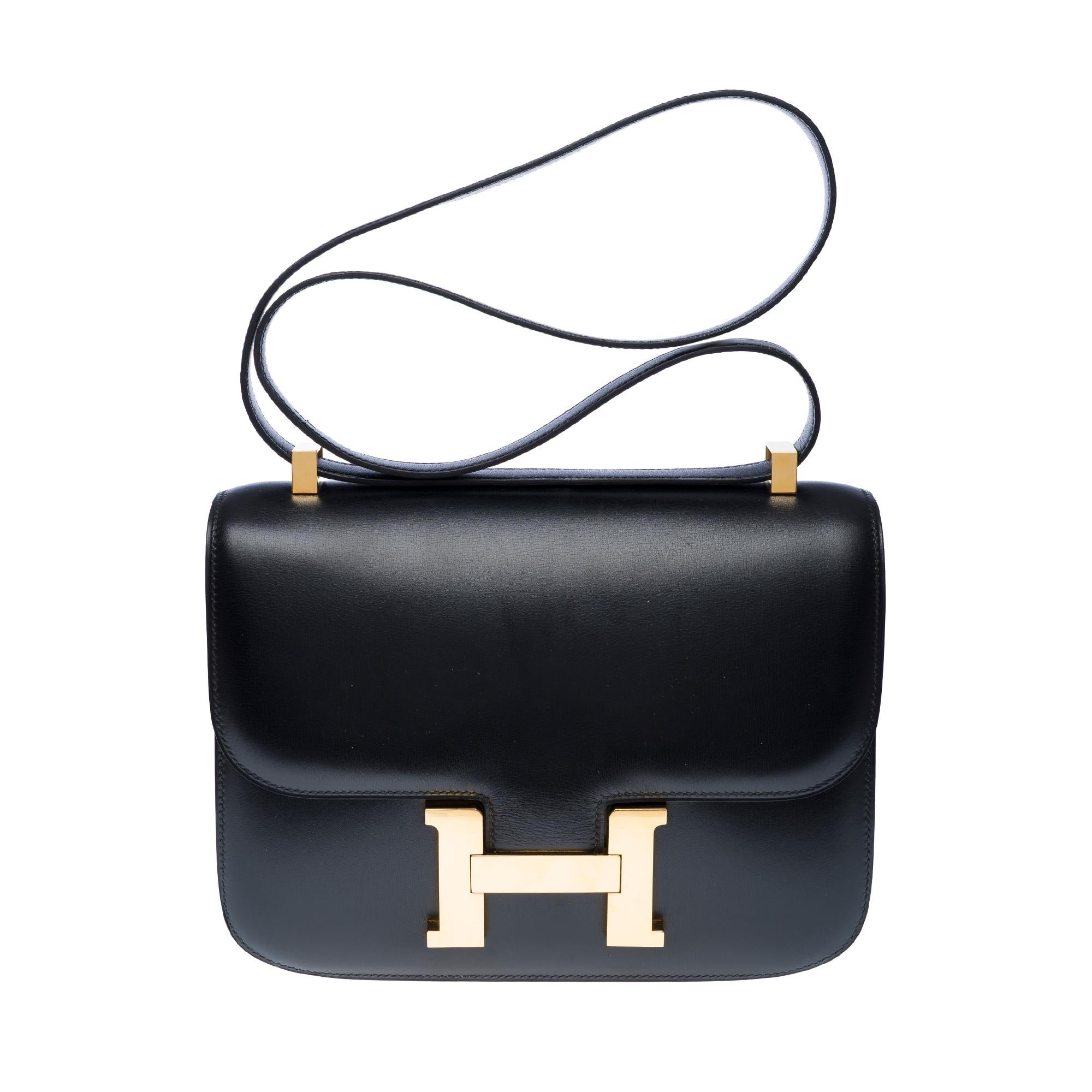Stunning​ ​Hermès​ ​Constance​ ​23​ ​shoulder​ ​bag​ ​in​ ​black​ ​box​ ​calf​ ​leather,​ ​gold​ ​plated​ ​metal​ ​trim,​ ​a​ ​black​ ​box​ ​calf​ ​leather​ ​shoulder​ ​strap​ ​allowing​ ​for​ ​shoulder​ ​or​ ​crossbody​ ​carry

Logo​ ​closure​ ​on​