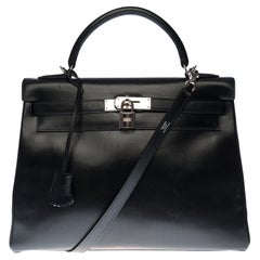 Rare Hermès Kelly 32 retourné handbag with strap in black calf leather, SHW