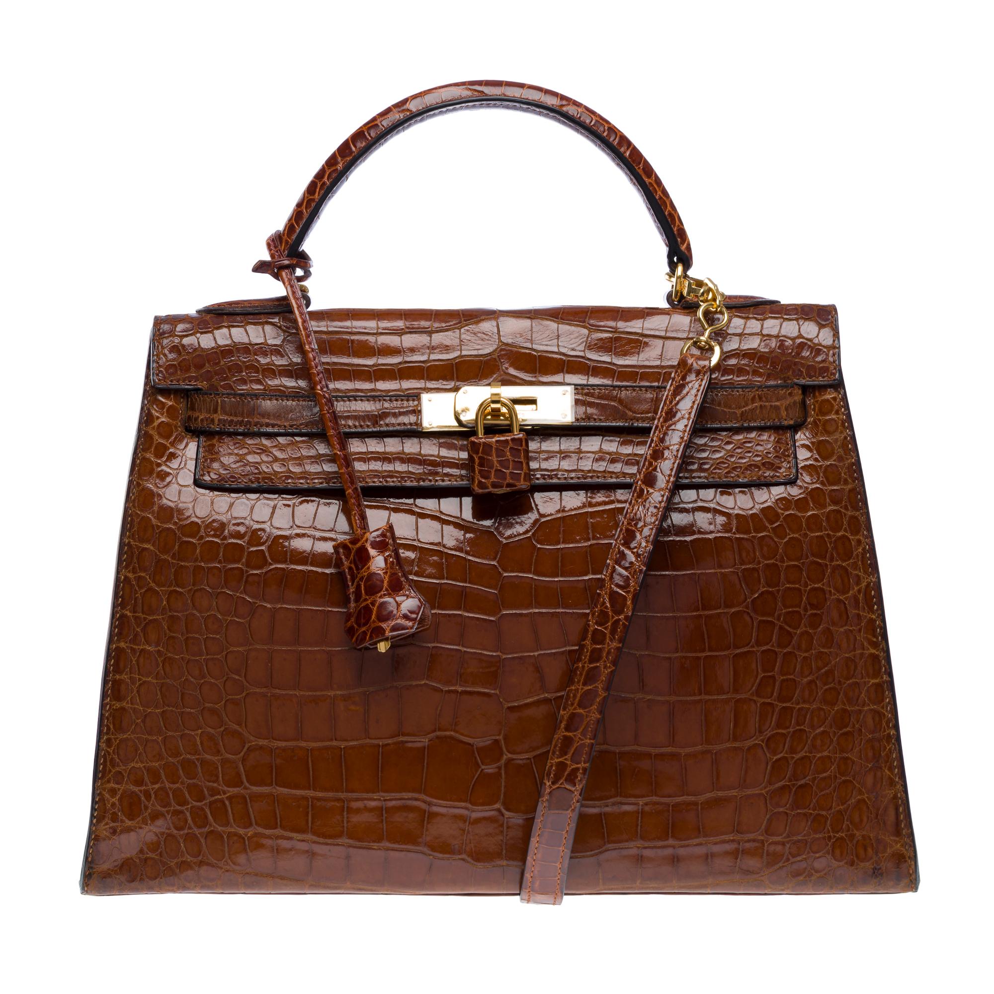 Exceptional​ ​and​ ​Rare​ ​Hermès​ ​Kelly​ ​32​ ​Sellier​ ​handbag​ ​strap​ ​in​ ​Cognac​ ​Crocodile​ ​Porosus​ ​leather,​ ​removable​ ​shoulder​ ​strap​ ​in​ ​cognac​ ​crocodile​ ​leather,​ ​gold​ ​metal​ ​hardware,​ ​single​ ​handle​ ​and​