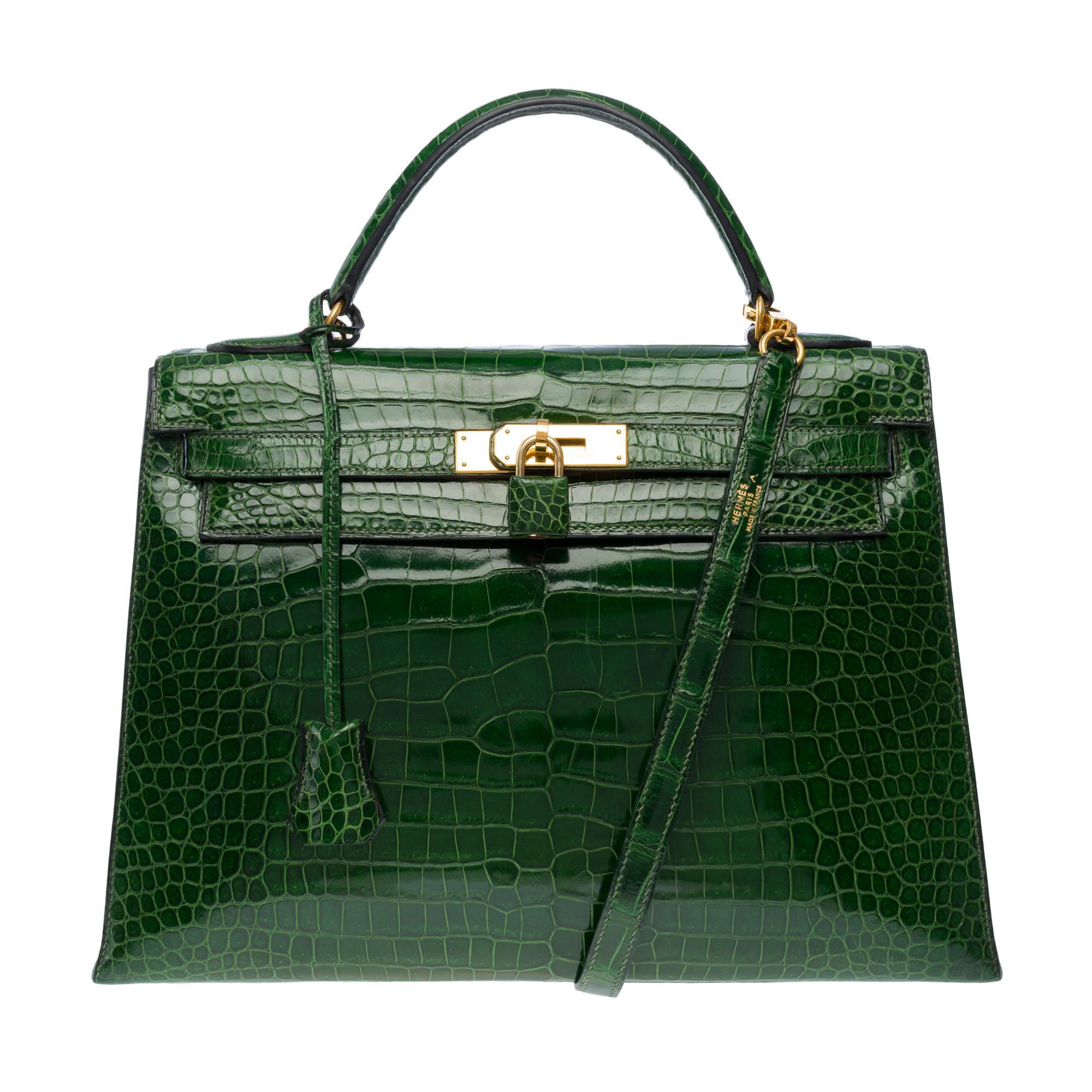 Exceptional​ ​and​ ​Rare​ ​Hermès​ ​Kelly​ ​32​ ​saddle​ ​handbag​ ​strap​ ​in​ ​Green​ ​Emerald​ ​Porosus​ ​Crocodylus​ ​leather,​ ​removable​ ​shoulder​ ​strap​ ​in​ ​green​ ​crocodile​ ​leather,​ ​gold​ ​plated​ ​metal​ ​fasteners​ ​and​ ​clasp,​