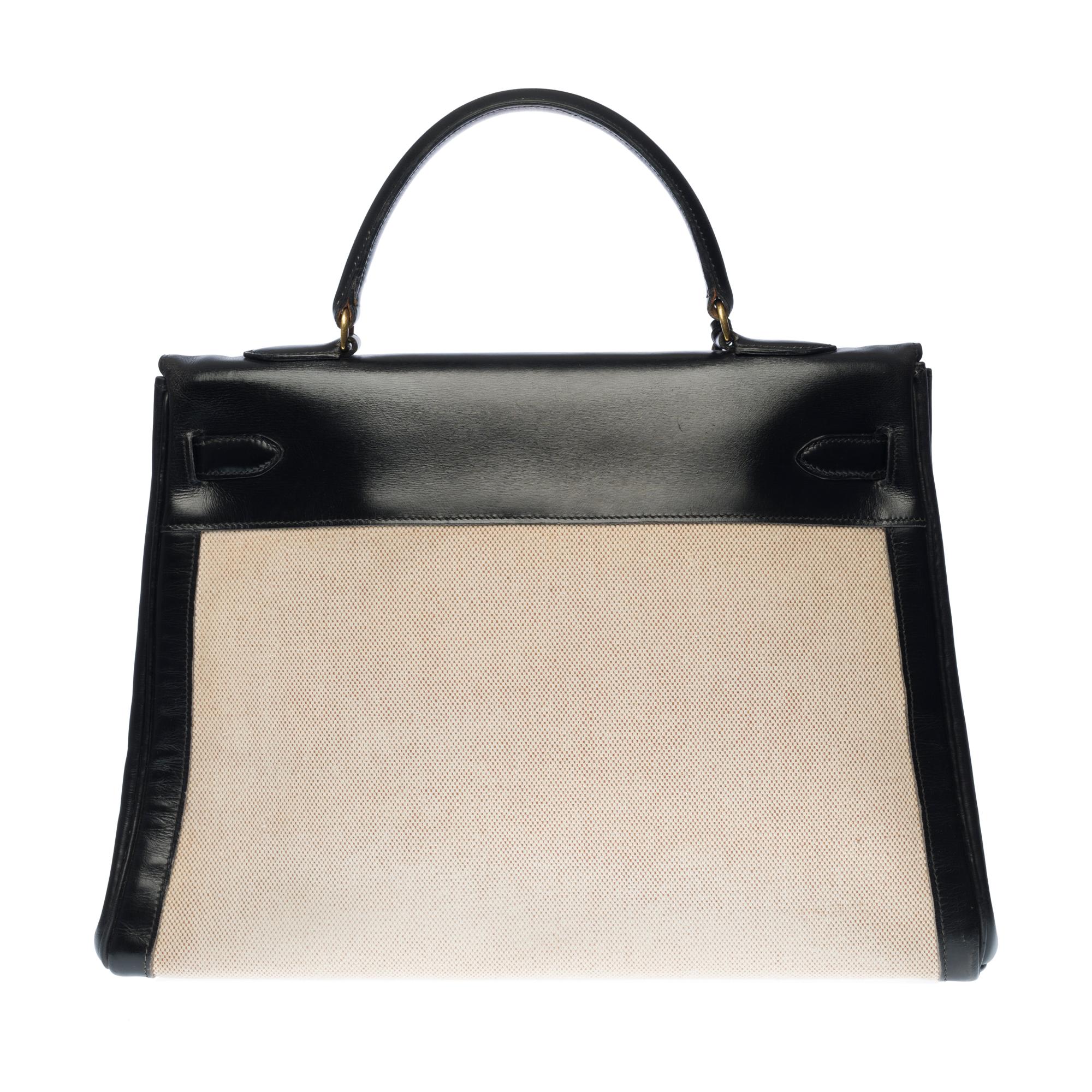 Gorgeous Hermes Kelly 35 cm handbag in black box calfskin leather and beige canvas, gold metal hardware, black leather handle, a removable strap in black leather box (not signed Hermès) allowing a hand or shoulder support.

Closure by flap.
Lining