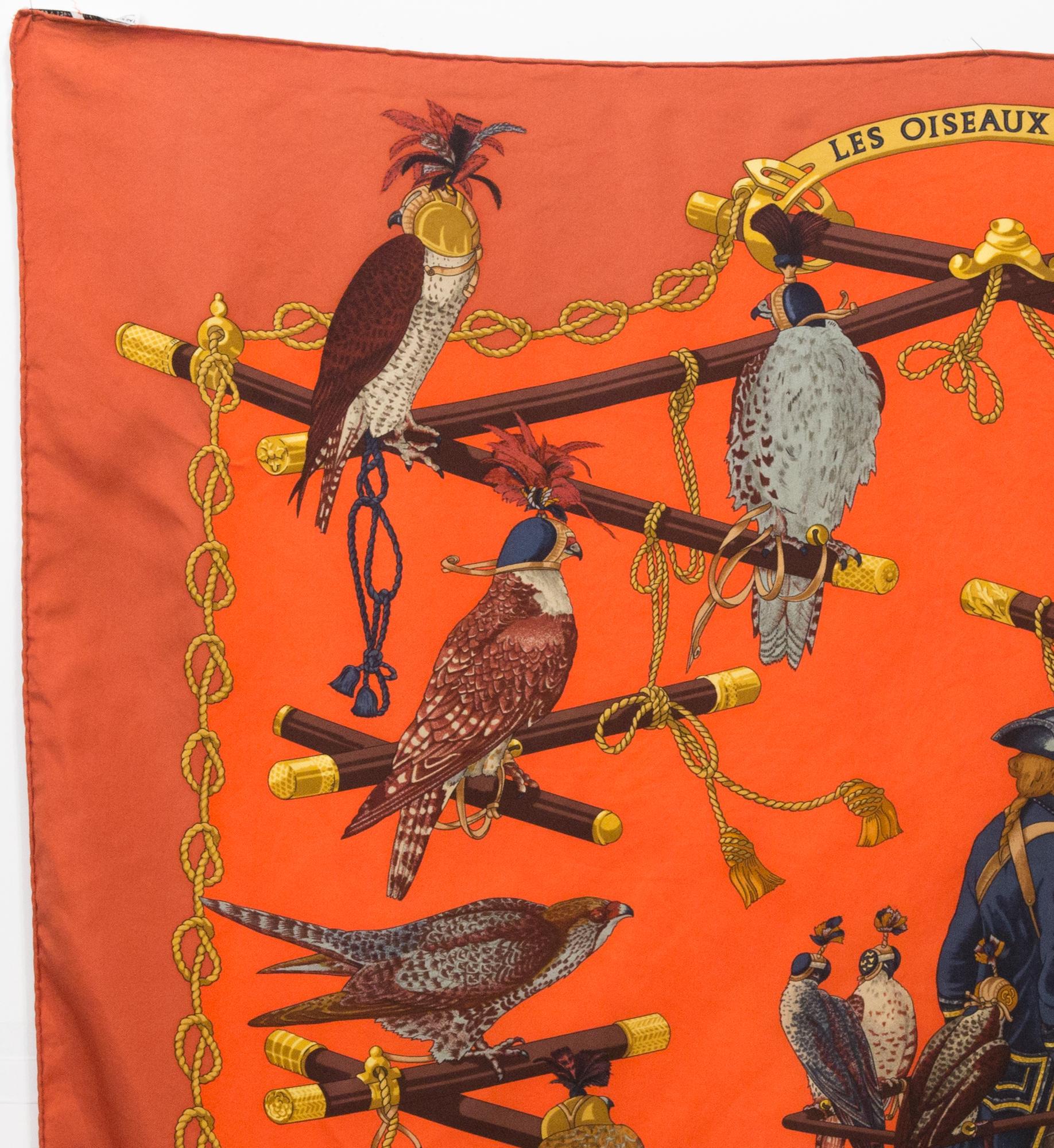 Hermès  « Les Oiseaux du Roy » by Cathy Latham silk scarf featuring an orange border, a Hermès signature. 
Circa 1994
In good vintage condition. Made in France.
35,4in. (90cm)  X 35,4in. (90cm)
We guarantee you will receive this  iconic item as