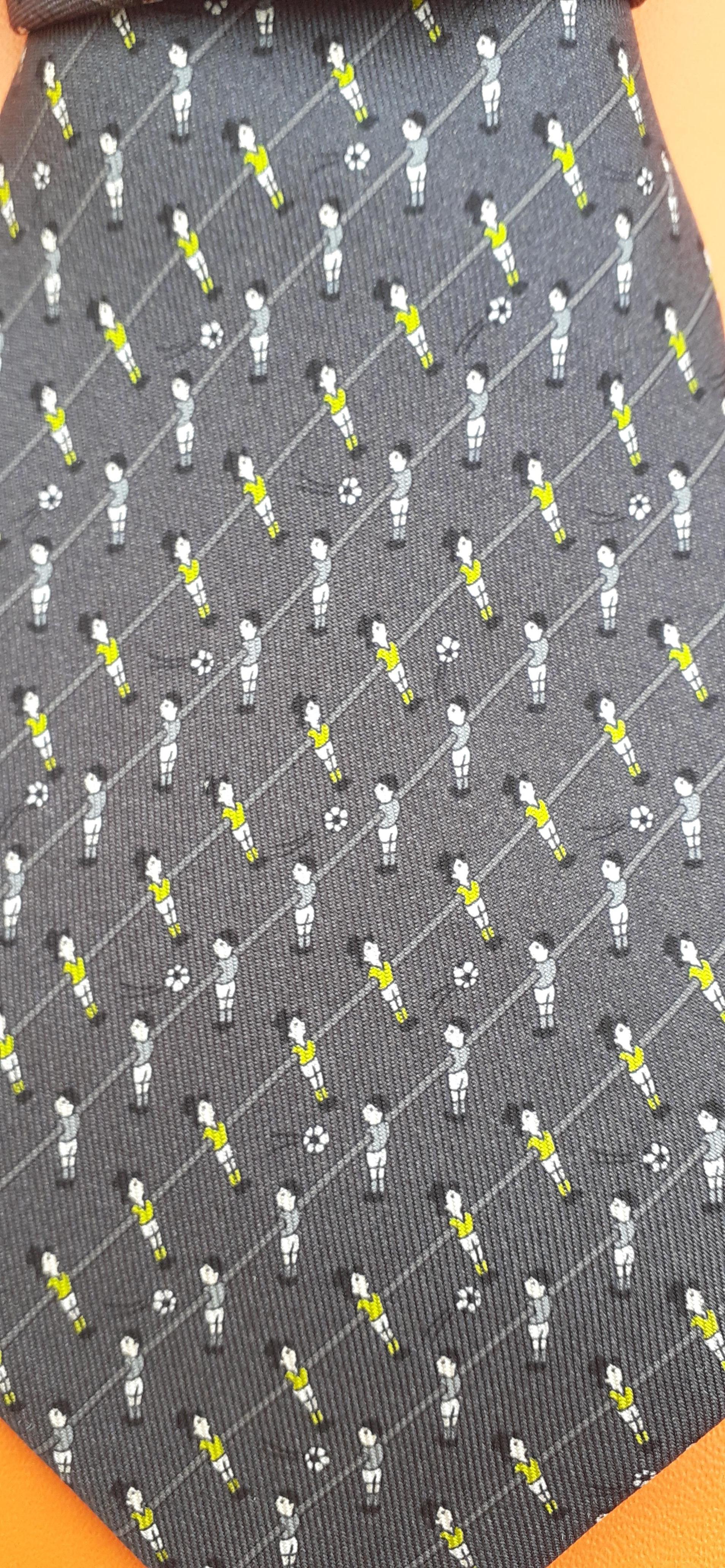 Cute and Rare Authentic Hermès Tie

Print: Baby Foot Players, Table Soccer

A goal and a small ball are hidden in the lining on the back

Made in France

Made of 100% Silk

Colorways: Dark Grey / White / Neon Green

Please note: Players' t-shirts