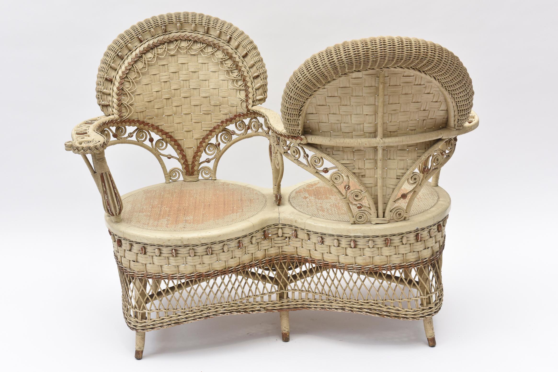 Perhaps the Rarest of all Victorian Wicker pieces, this parlor chair was used for Ladies to gossip while not facing one another or to limit contact between courting couples. Victorian to its extreme, it has curlicues, a woven beaded apron with open