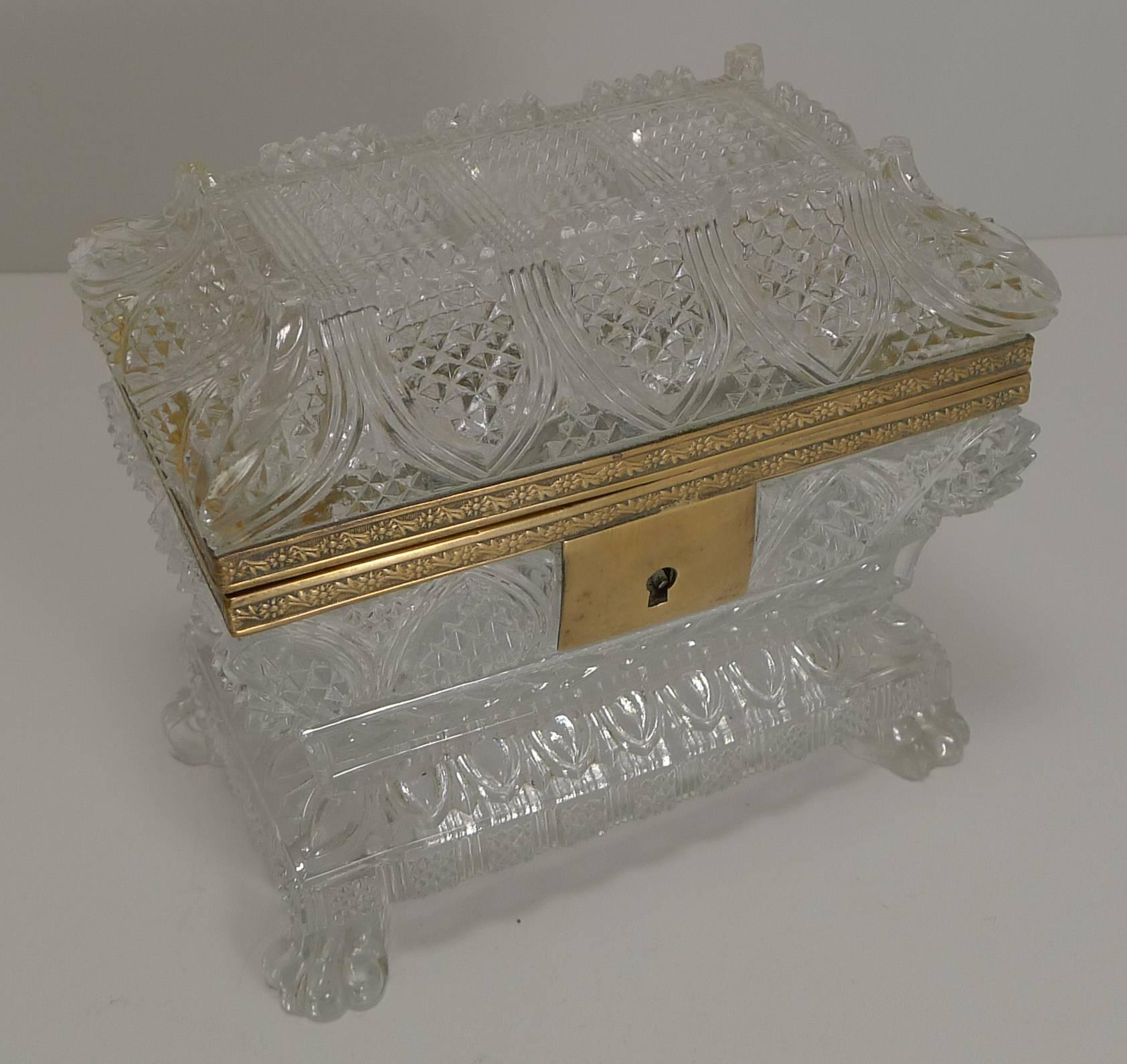 A fabulous shaped Baccarat box with doré bronze mounts. This is a rare example, the shape deeply and intricately cut incorporating four cut lion's paw feet.

Dating to around 1860, this exquisite jewelry box is in excellent undamaged condition. 5