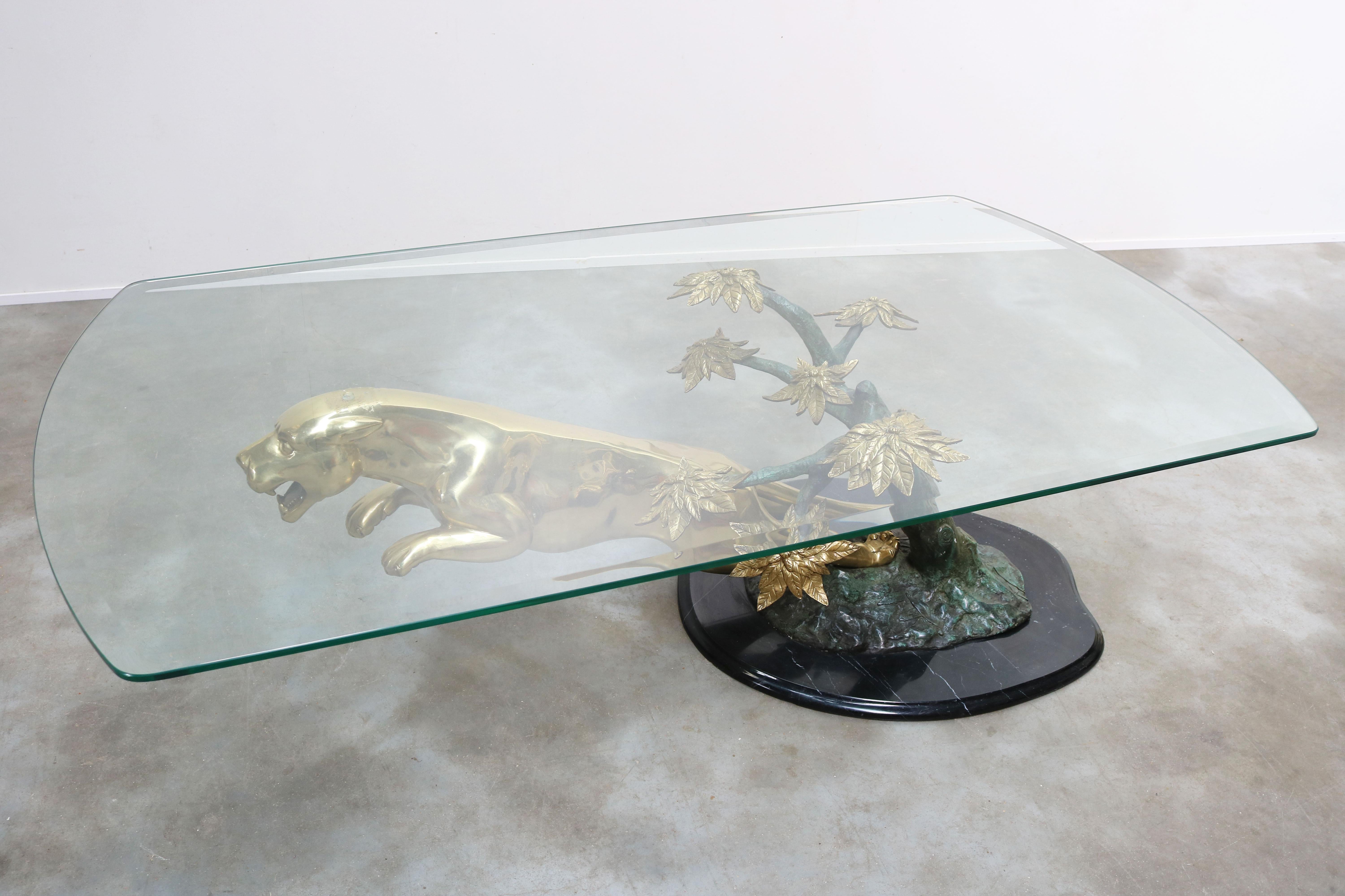 Exceptional & timeless! This ''Leaping Panther'' Hollywood regency coffee table by Maison Jansen 1960.
A stylish combination of bronze & brass presented on a carved base of Spanish ''Nero Marquina'' marble.
The panther is sculpted in a leaping