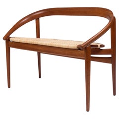 Used Petite Danish modern sofa with horseshoe curved teak and woven light cane seat
