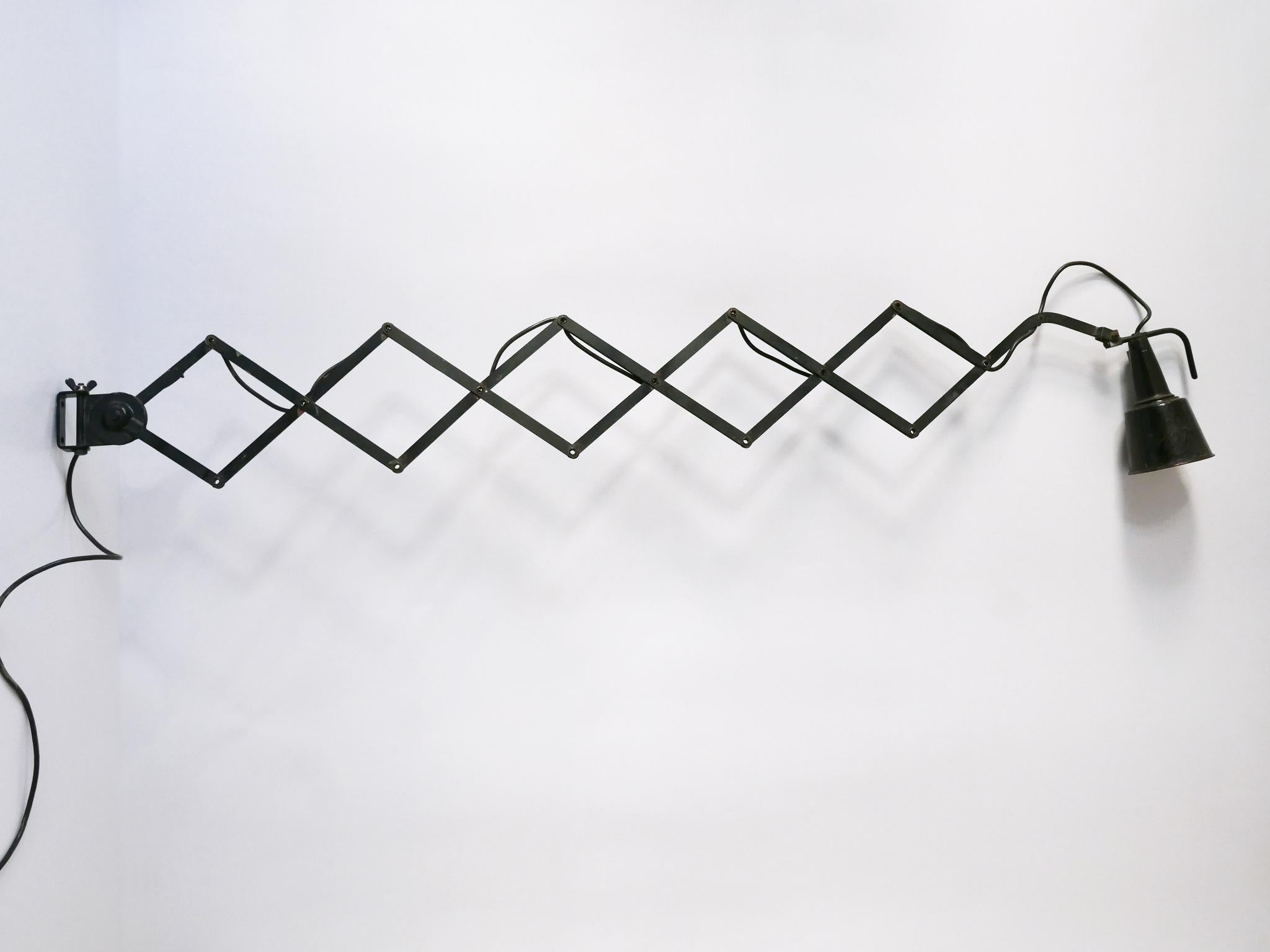 Huge, articulated Bauhaus scissor wall lamp. Adjustable and extendable arm. Lamp shade adjustable in every position. Extendable between 18.11 –  66.93 in. (46 – 170 cm) A real work shop or desk light. Designed by Wilhelm Bäder, Germany, 1930s.

The