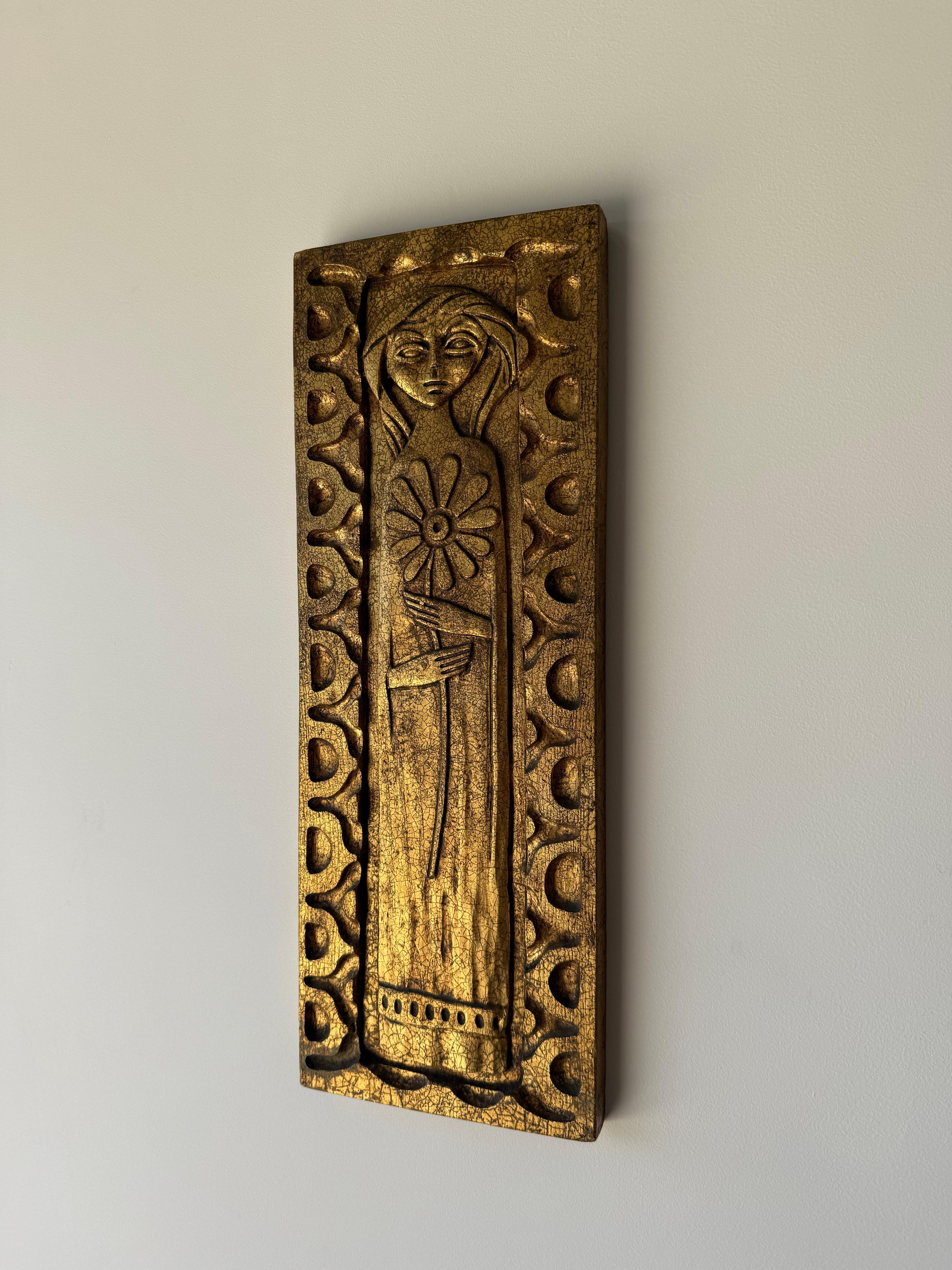 A rare Flora de Madera wall panel by renowned California designer Evelyn Ackerman, produced by ERA Industries in the 1960s. This sculptural bas-relief depicts a stylized female figure holding a flower, surrounded by Ackerman’s signature geometric