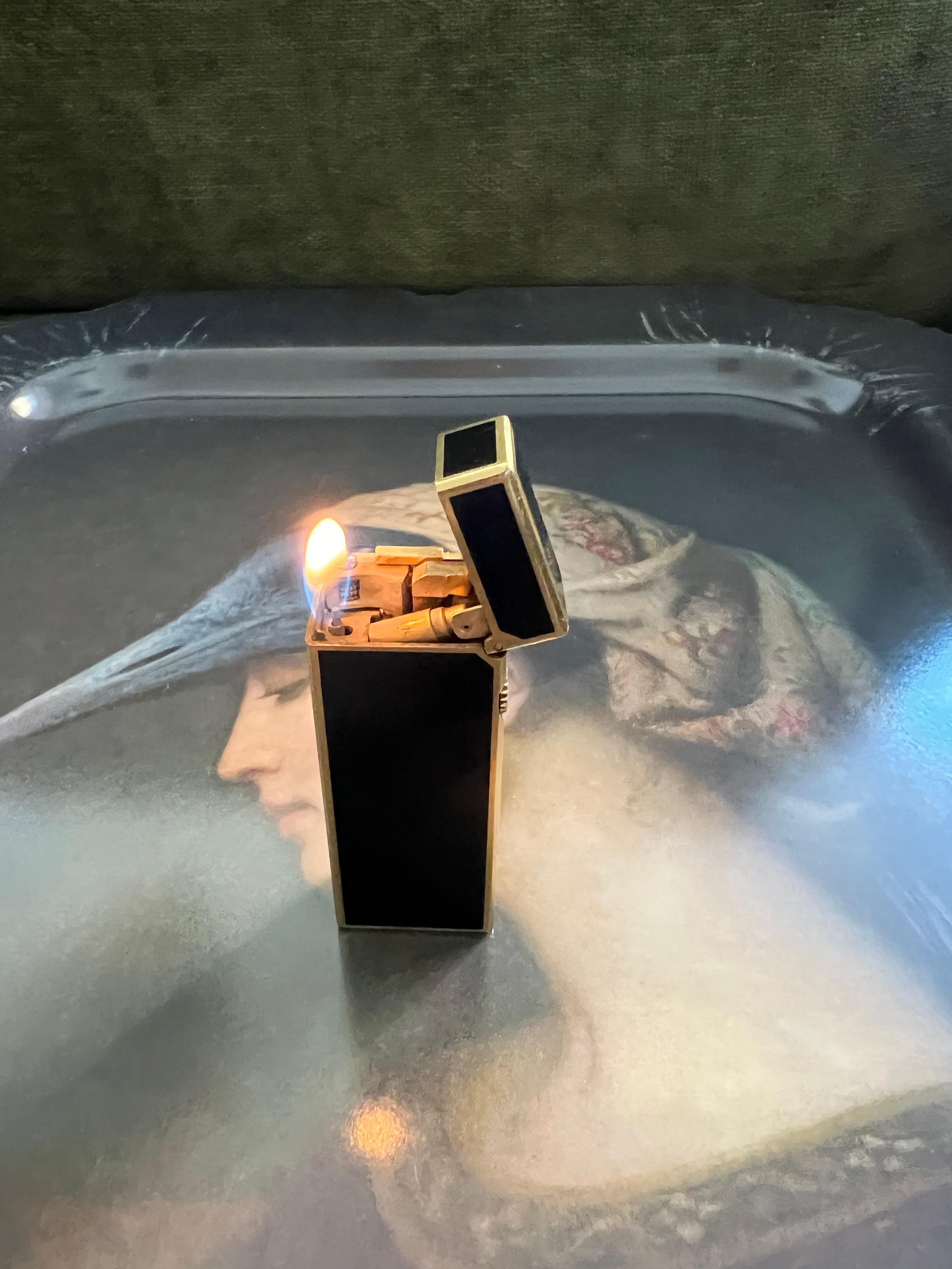 Elegant and Chic Rare Vintage Dunhill gold plated and Black lacquer Swiss Made lighter In mint condition.
Works perfectly. 
Iconic and beautifully engineered piece with rare lacquer condition.
In original box which is in mint condition, as good as