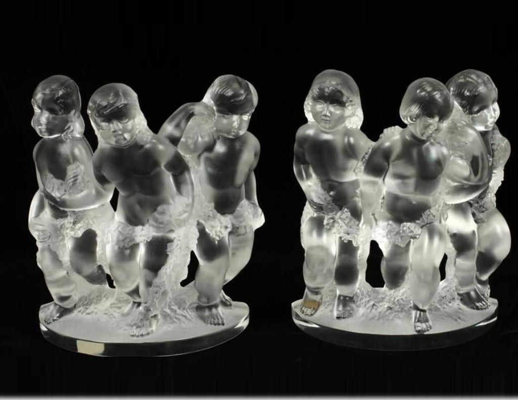 The Following Items we are offering is an Estate Pair of Rare Standing Lalique Sculptures Depicting Three Children Standing together Holding Wreath of Garland. Signed Lalique, France on bottom. From an Important New York City Estate Collection. We