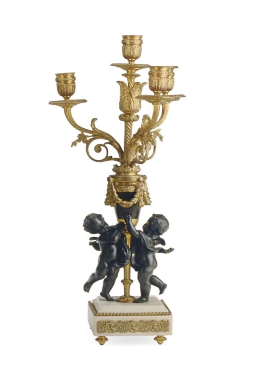 The Following Item we are Offering is A Magnificent Louis XVI Style Gilt Metal and Bronze Mantle Cherub 3 Pc Clock Set, circular white enamel dial with Floral Wreaths and Numbers enclosing reticulated hour/minute hands above twin key escapements