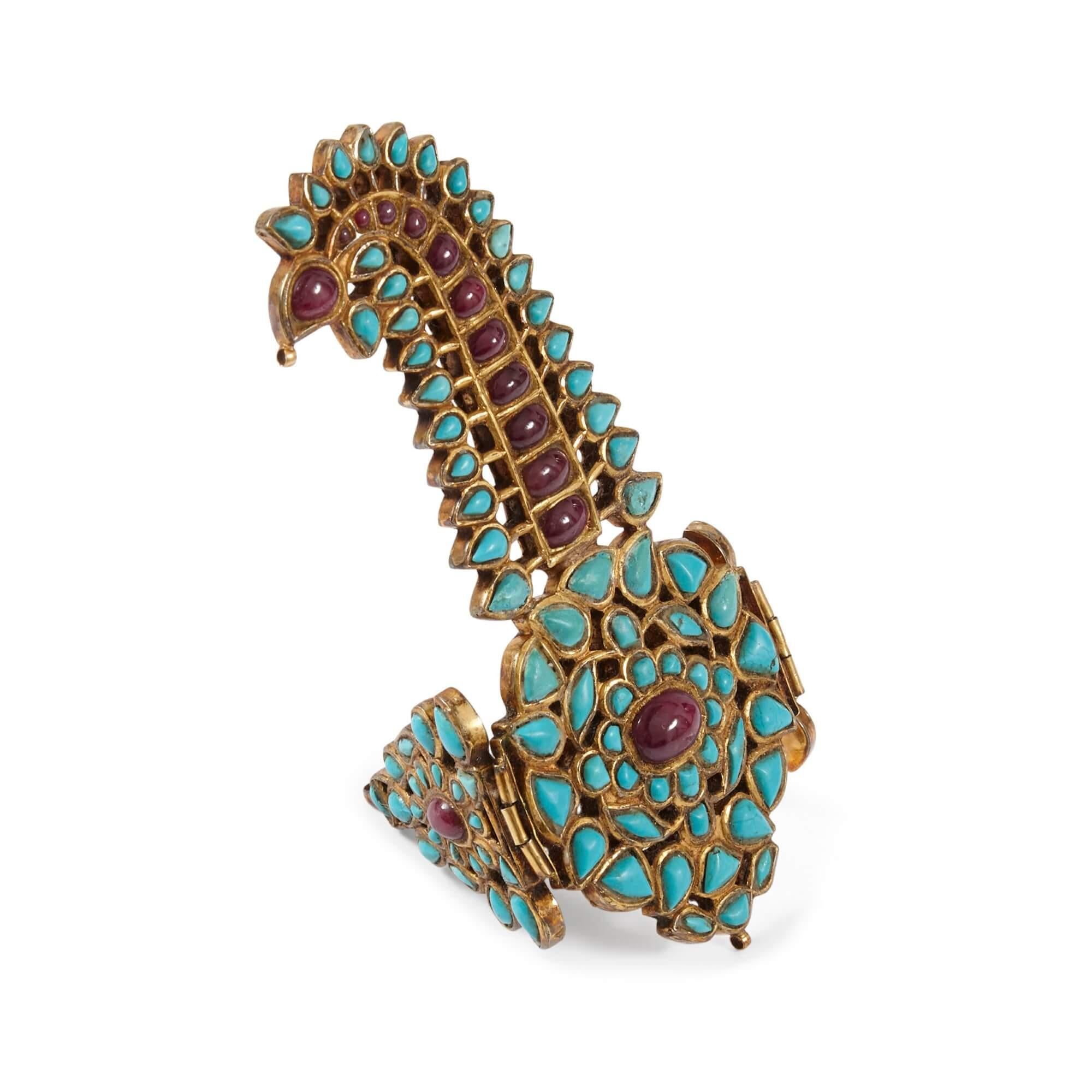 Rare Indian gold, ruby and turquoise Sarpech turban ornament
Indian, 19th Century
Sarpech: height 12cm, width 14cm, depth 0.5cm
Case: height 19cm, width 20cm, depth 4cm

Similar to works in the Royal Collection, this beautiful ornament is a