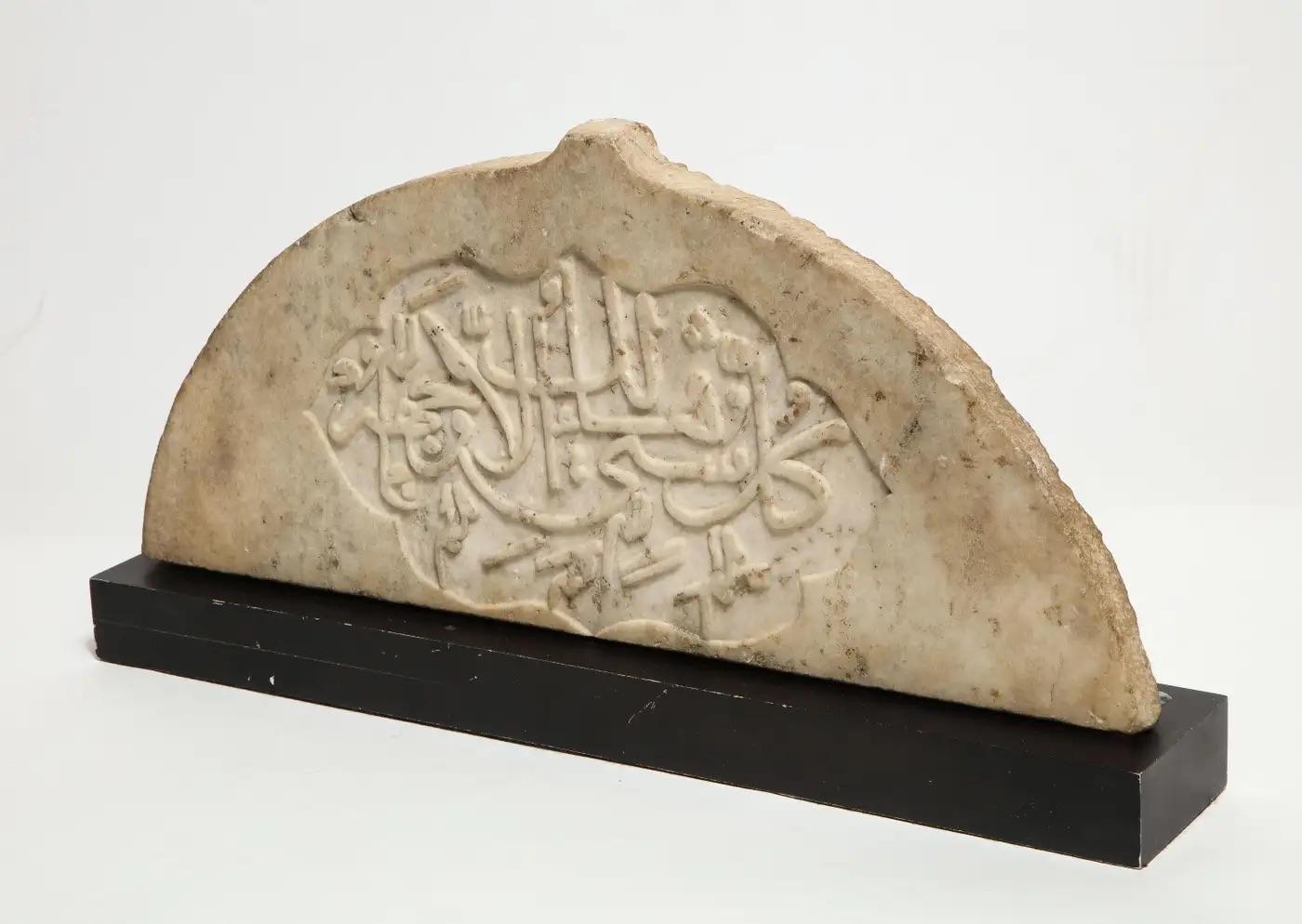 Raro azulejo de mármol caligráfico tallado islámico de la India, hacia 1860  

Tallada a mano con una cartela cuspidada que contiene líneas de densa caligrafía thuluth. Sobre un soporte hecho a medida.   

Pieza extremadamente fina.  

Medidas: