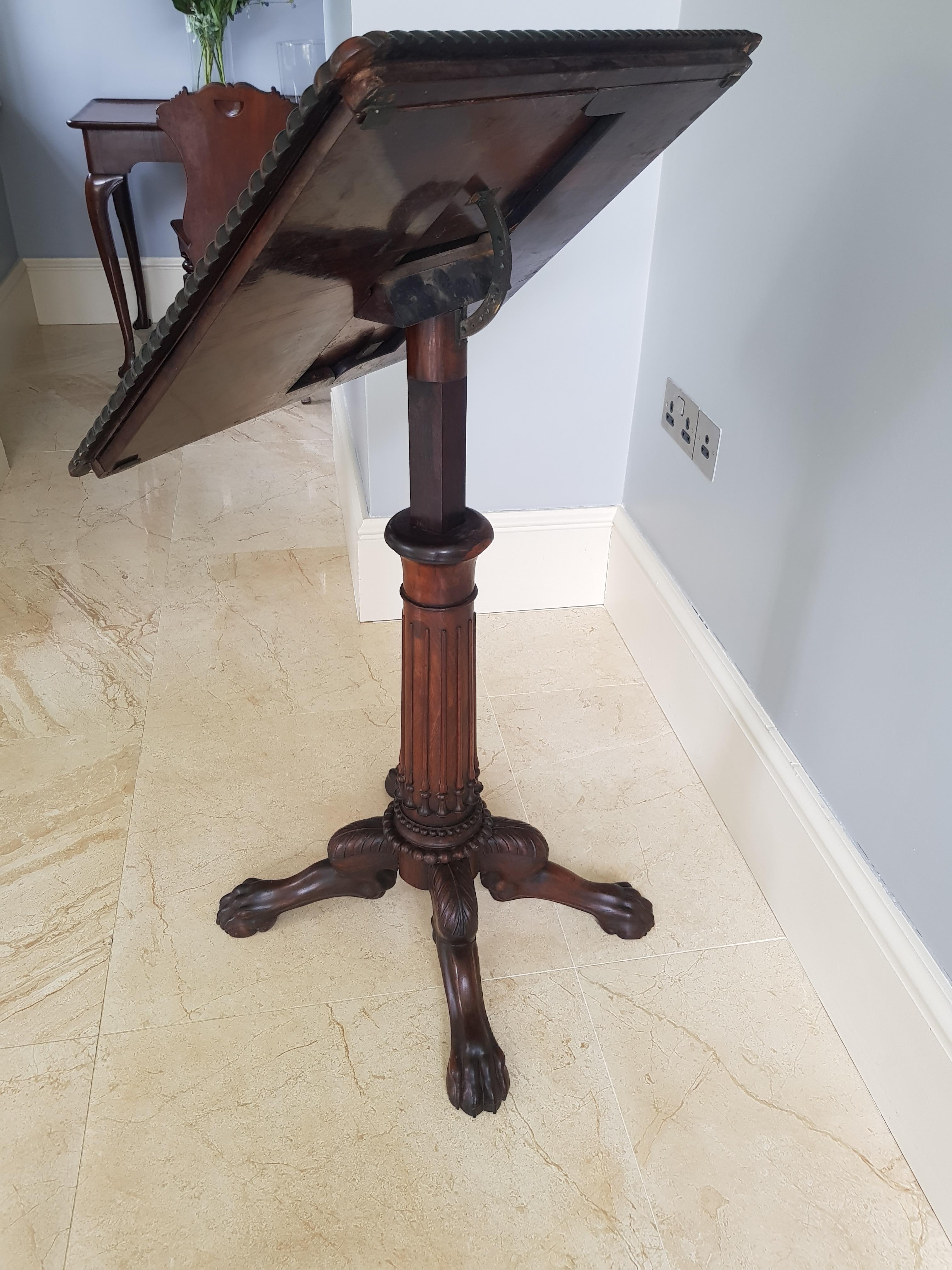 A highly unusual Irish rosewood lectern or Artists table, 

The top surface with gadrooned surround constructed from fine rosewood timber measuring 60cm x 49cm. The pitch and height adjustable to suit the users’ needs supported by a central column