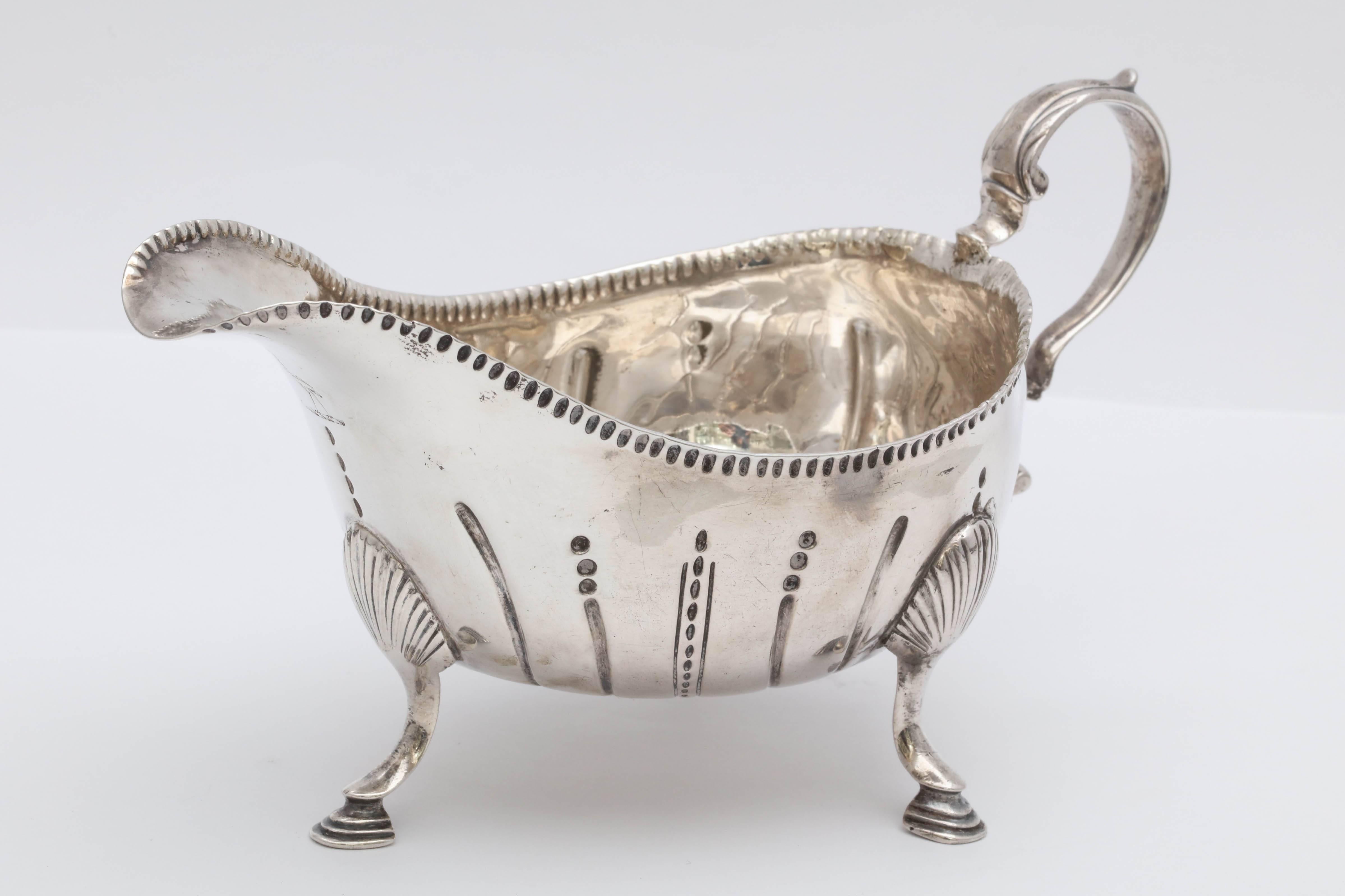 Beautiful and rare Irish, George III, Sterling silver footed sauce/gravy boat, Dublin, 1771, John Lloyd - maker. Graceful design. Lightly gilded inside. Measures 6 1/2 inches from edge of handle to edge of spout x 3 3/4 inches high (to top of