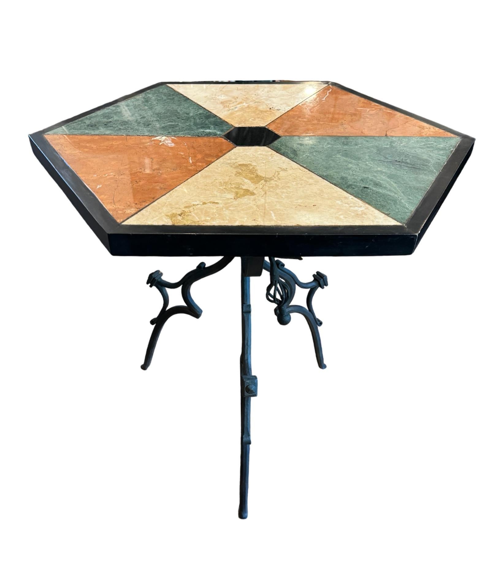 Discover a truly unique accent end table that seamlessly blends artistry and functionality. This striking piece features a hexagonal-shaped top, beautifully adorned with a stunning array of multi-colored marbles and granite insets, each contributing