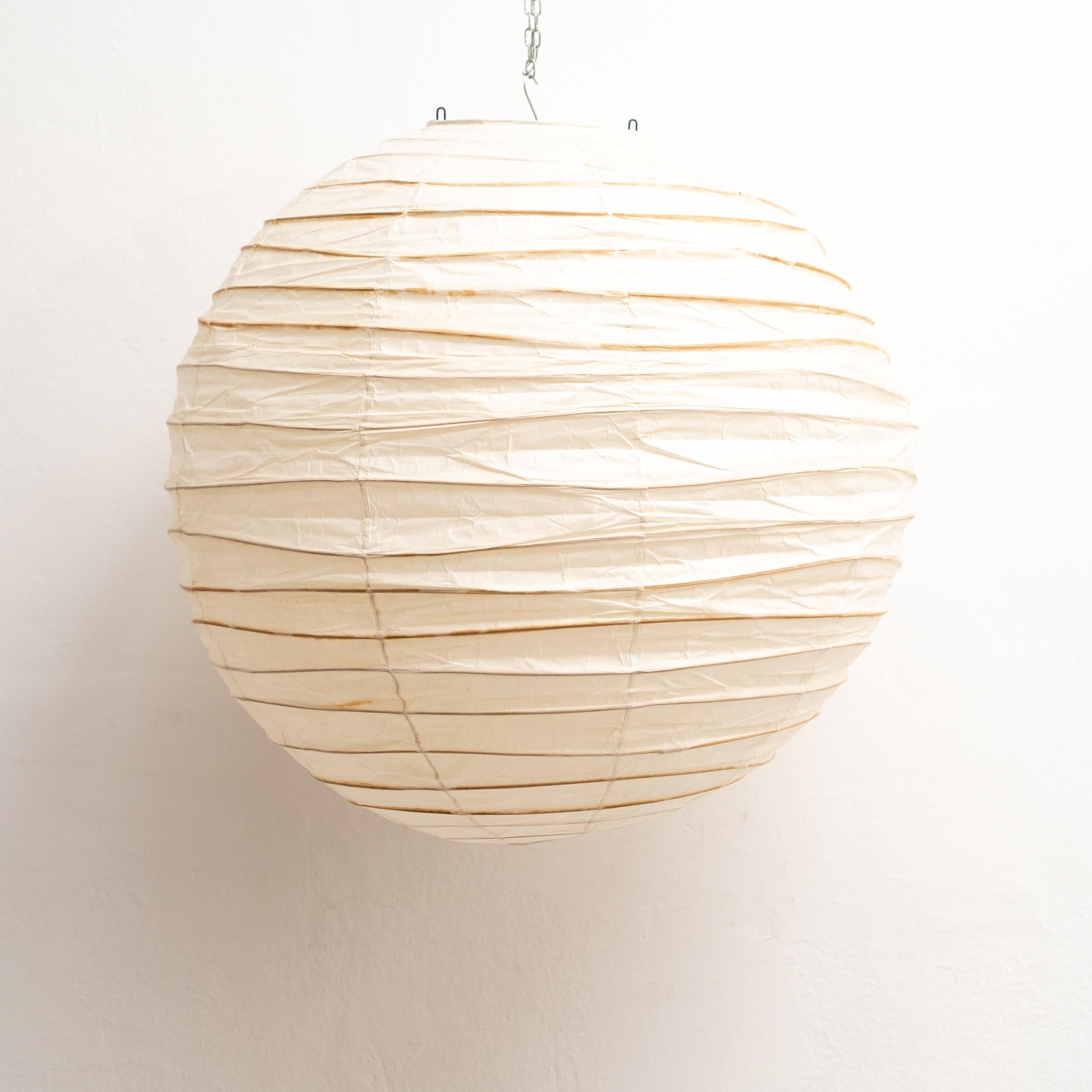 Discover the timeless allure of the Isamu Noguchi Akari Lamp, model 75D, a pendant lamp designed around 1950 and manufactured by Ozeki & Co. Ltd. in Japan. This mid-century modern masterpiece features a bamboo ribbing structure covered by washi