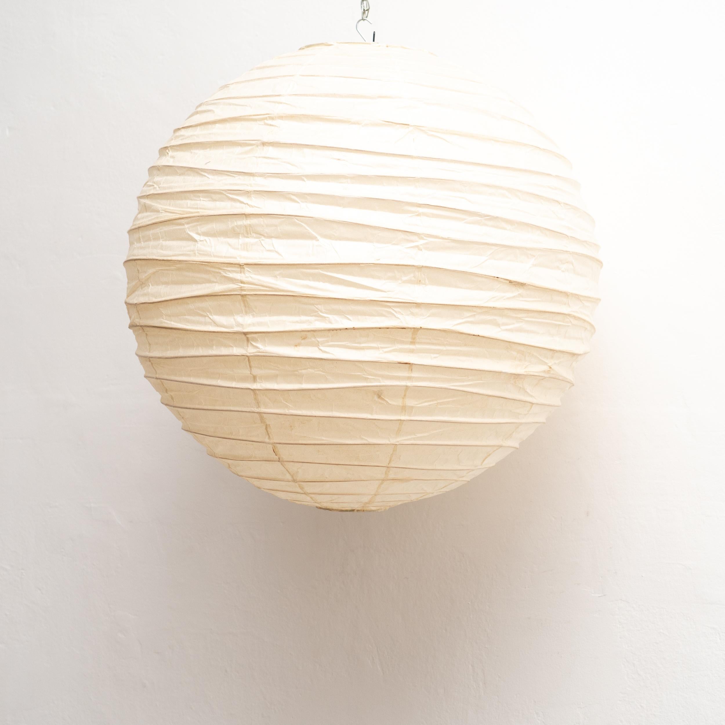 Discover the timeless allure of the Isamu Noguchi Akari Lamp, model 75D, a pendant lamp designed around 1950 and manufactured by Ozeki & Co. Ltd. in Japan. This mid-century modern masterpiece features a bamboo ribbing structure covered by washi