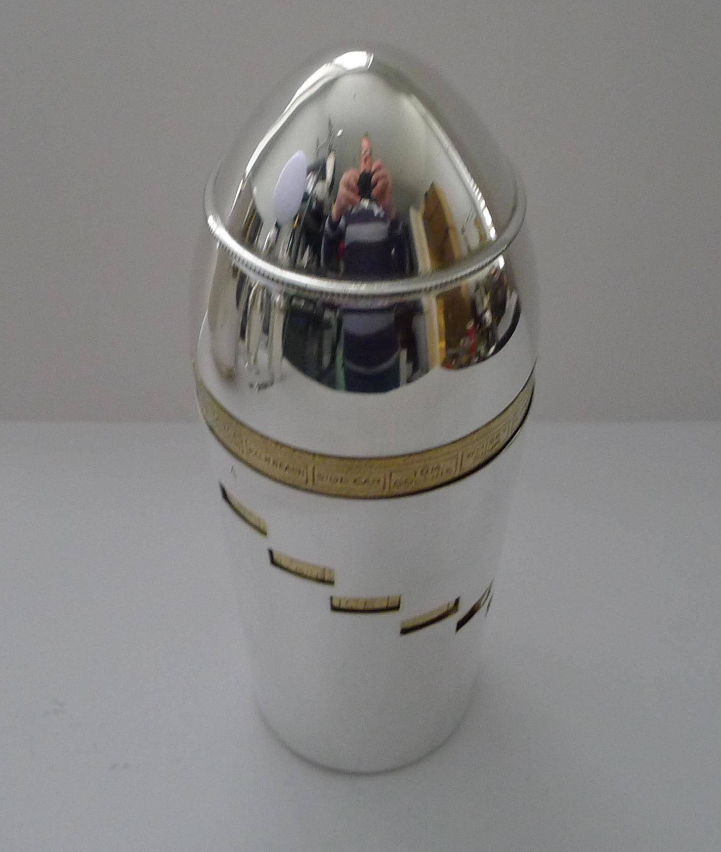A magnificent vintage Italian cocktail shaker in silver and gold plate dating to circa 1940.

Shaped in the form of a bullet, the body is made up of two components, gold plated on the inside and silver plated on the outer wall; choose your desired