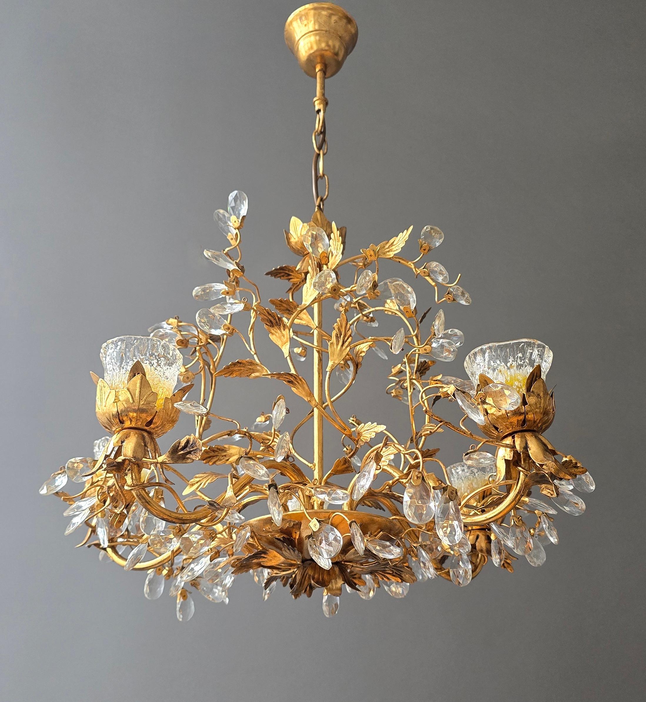 A refined and highly decorative Italian chandelier, crafted in gilt metal with a rich botanical structure of leaves and winding branches. The design is adorned with numerous faceted crystal droplets that sparkle like morning dew on a vineyard, a