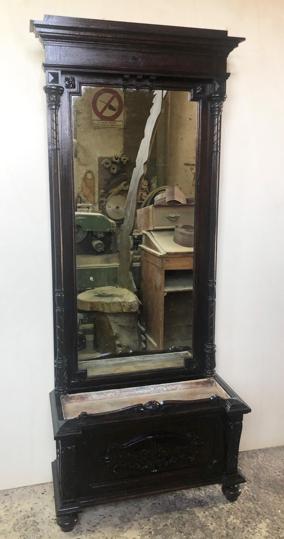 Rare Italian furniture from 1880, ebonized, with original mirror and carvings. Flower holder at the bottom.
The cabinet was at the entrance of a large Florentine country villa with a vase of flowers at the bottom.
The paint is original in patina,