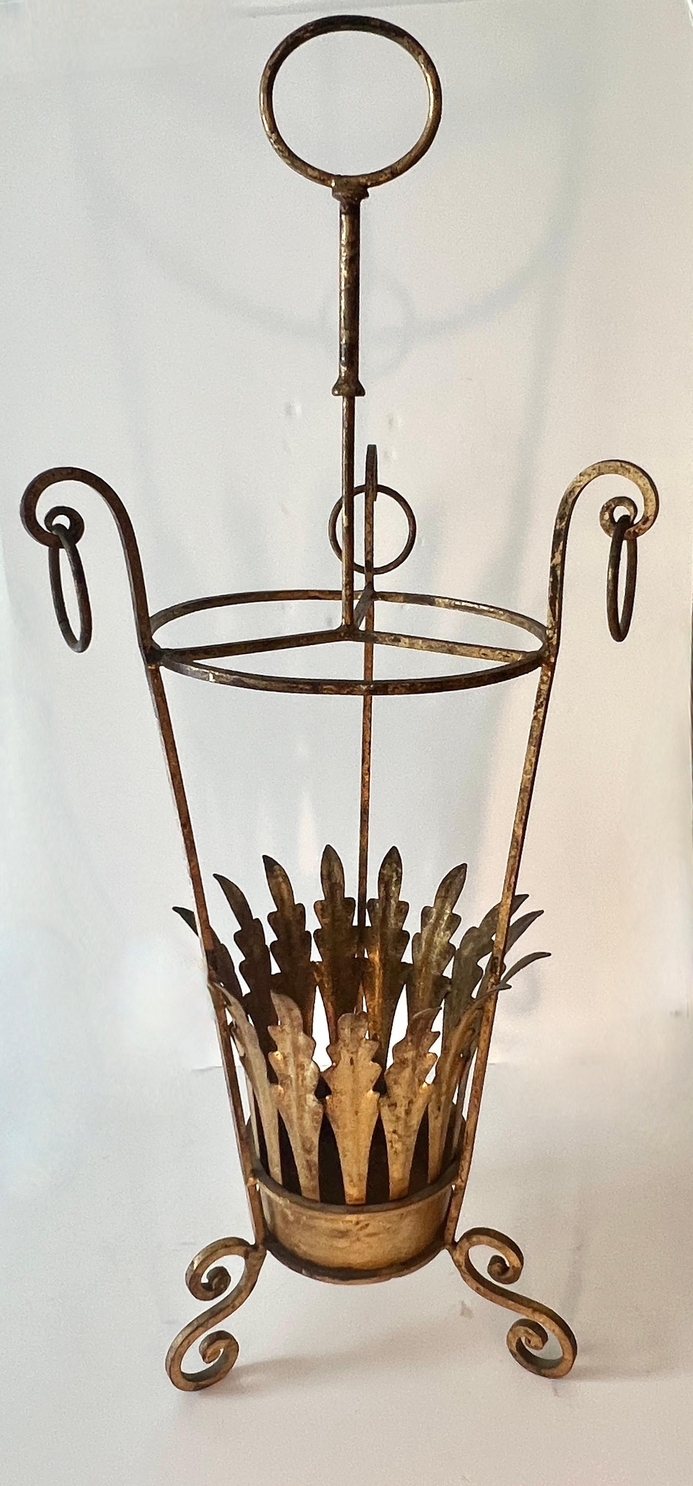 A superb, functional and very decorative Umbrella stand.  The stand is gilt metal from Italy.  The classic Italian rings, the ring to carry and the leaves, set this umbrella stand from many others.

A complement to any entry, residential or