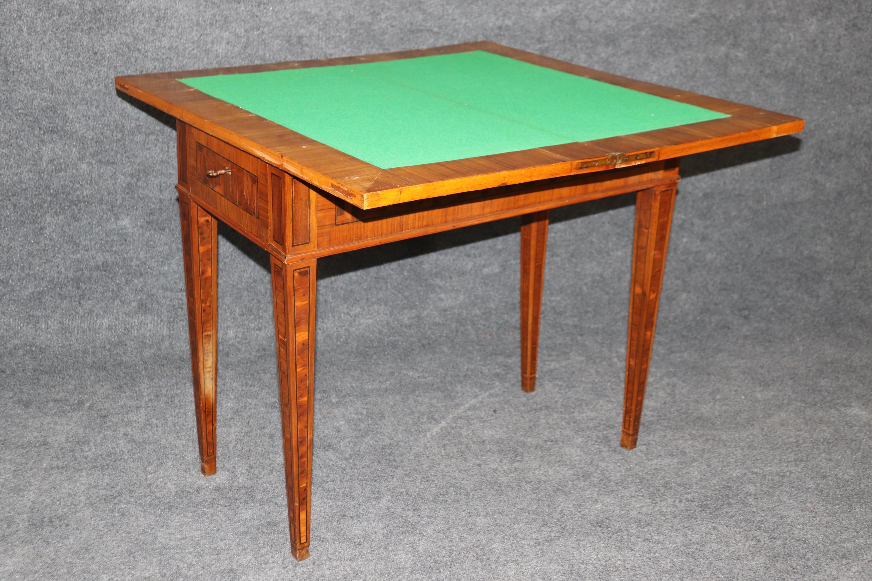 This is a rare and unique optical illusion inlaid rosewood and Olivewood games table with new felt. The table is a true work of art and has absolutely wonderful inlay and dark rosewood and lighter olivewood. The table dates to the 1780s era and is