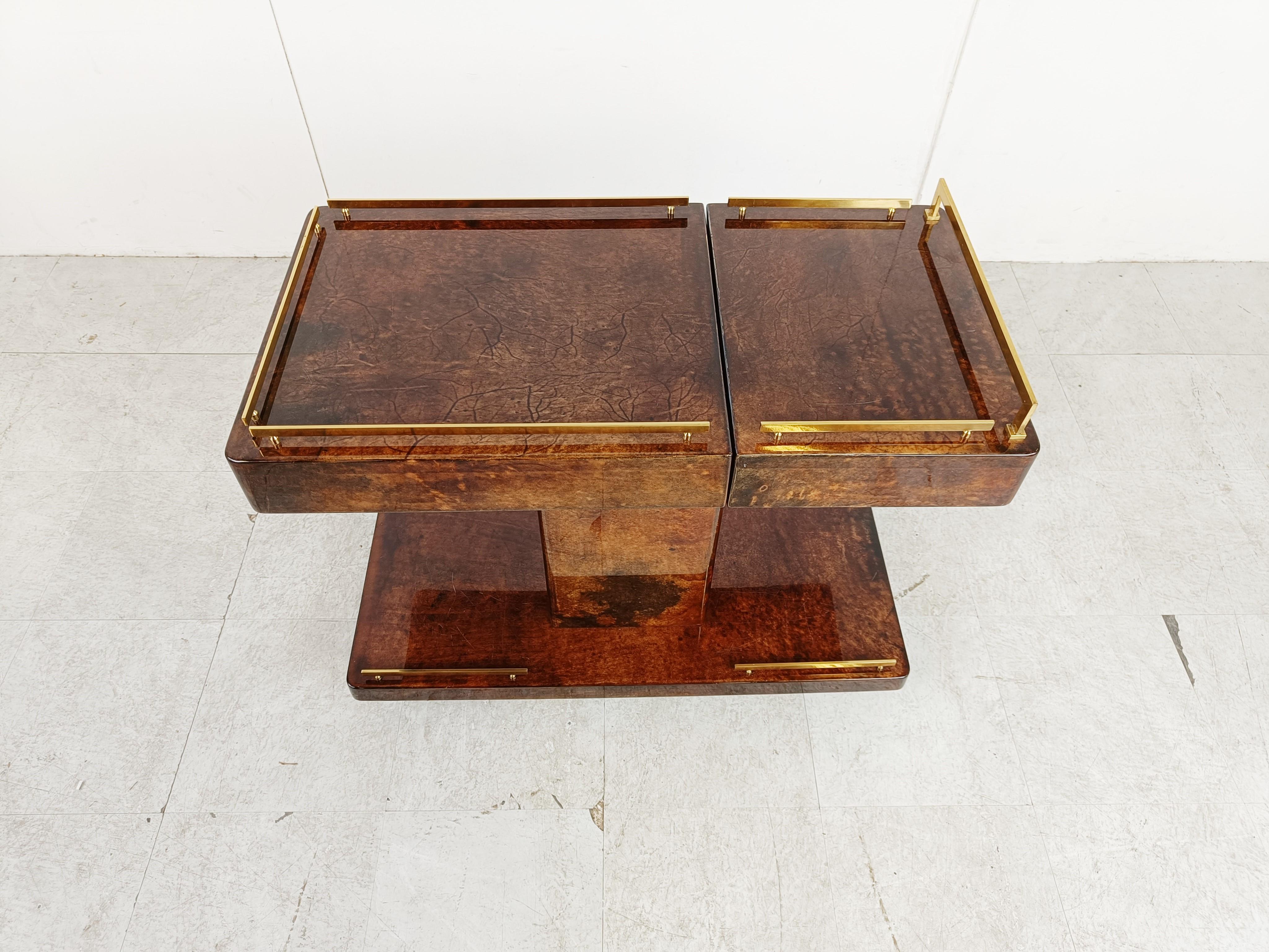 Very rare hidden bar Aldo Tura Goatskin or parchment bar cart. This bar cart was made in Italy in the 1960s. 

Constructed of thickly lacquered goatskin / parchment and gilt metal hardware. 

Can be used as drink trolley or side table.

The top