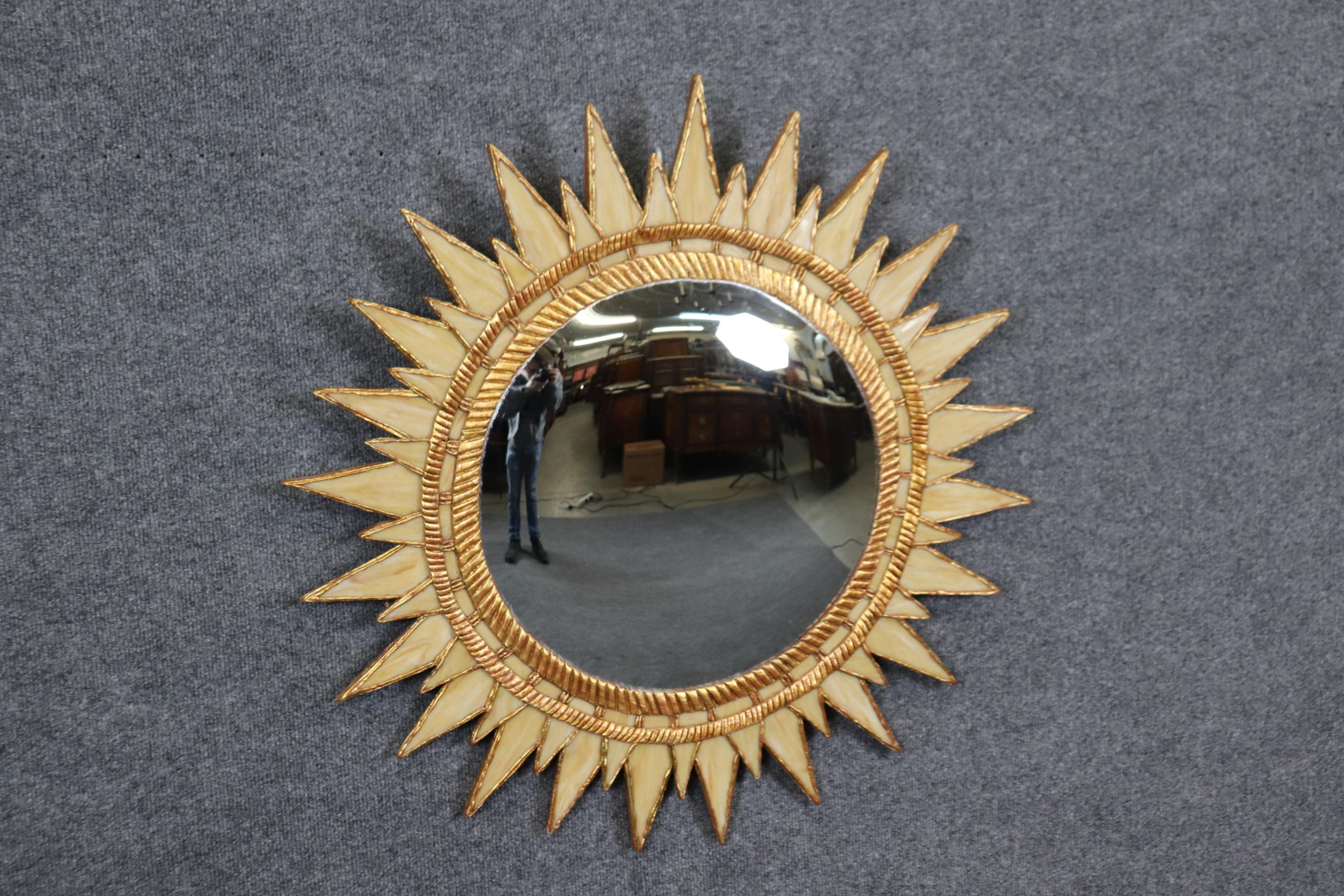 This is a rare and unique mirror made of slag glass panels wirthin a beechwood frame in creme and a gold leaf gilded finish. The mirror is absolutely exceptional-a true survivor or time with no aparent damage the the convex mirror or the slag glass